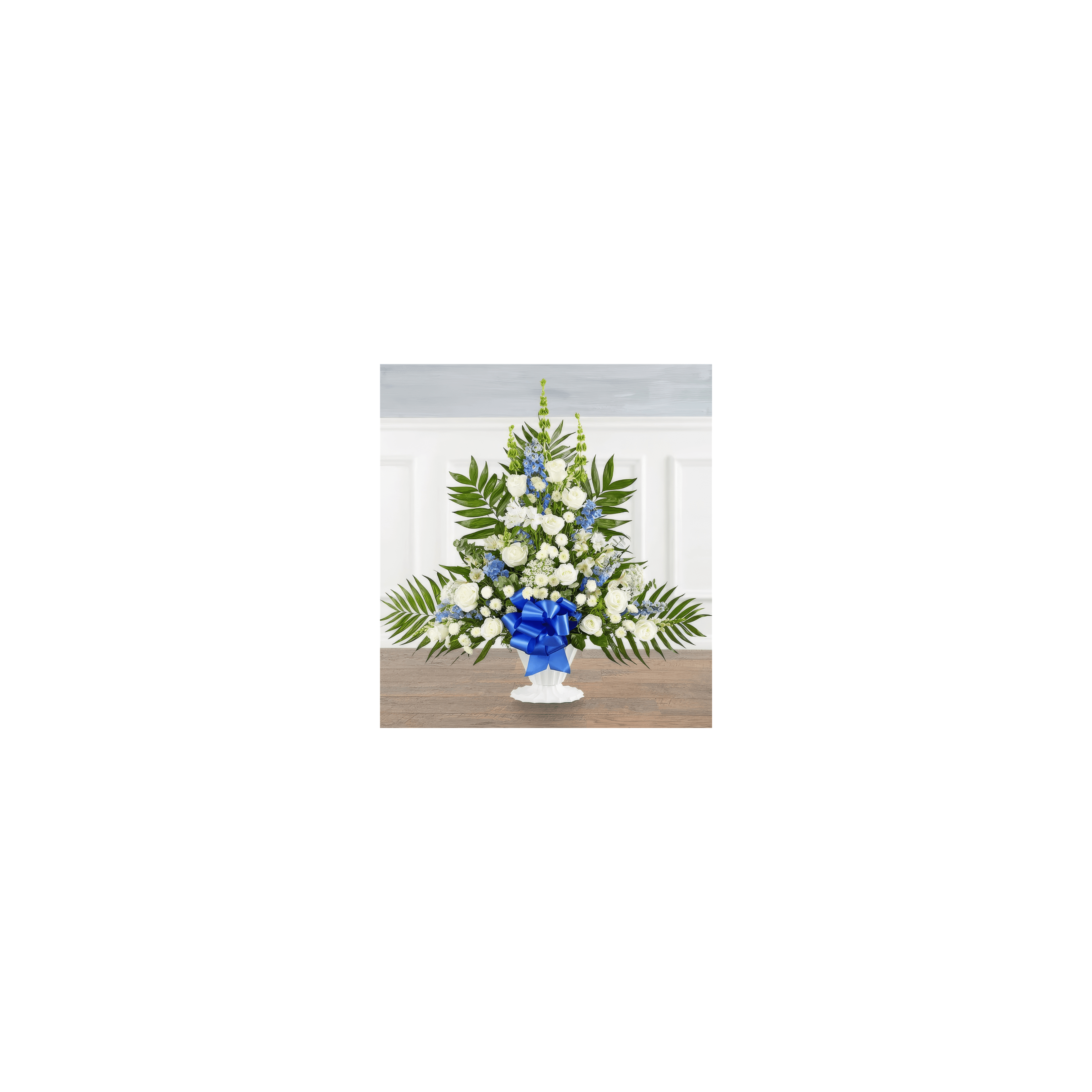 A beautiful arrangement of white roses, blue flowers, and greenery creates an elegant centerpiece.