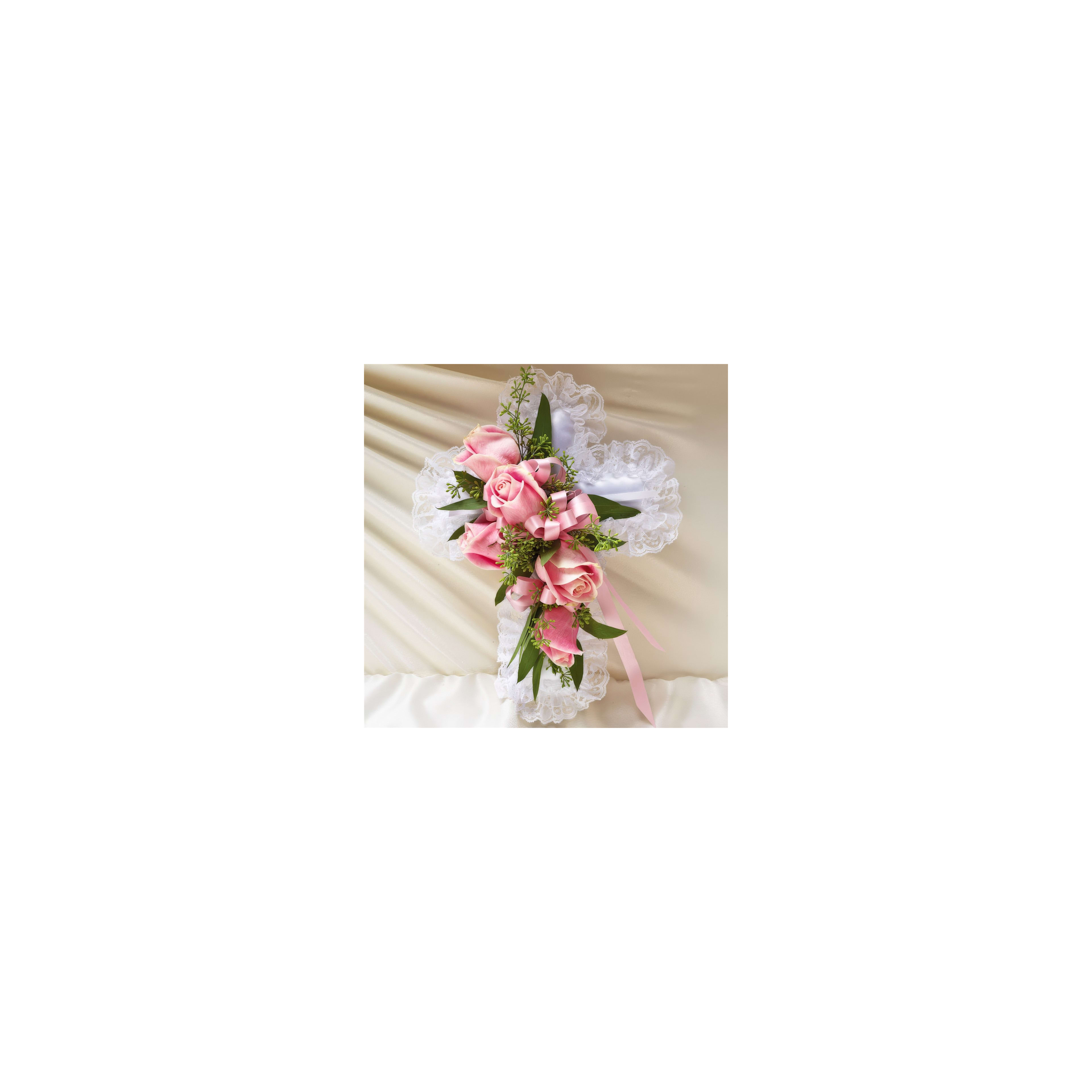 A beautiful pink rose and greenery display on a lace cross honors a cherished memory.