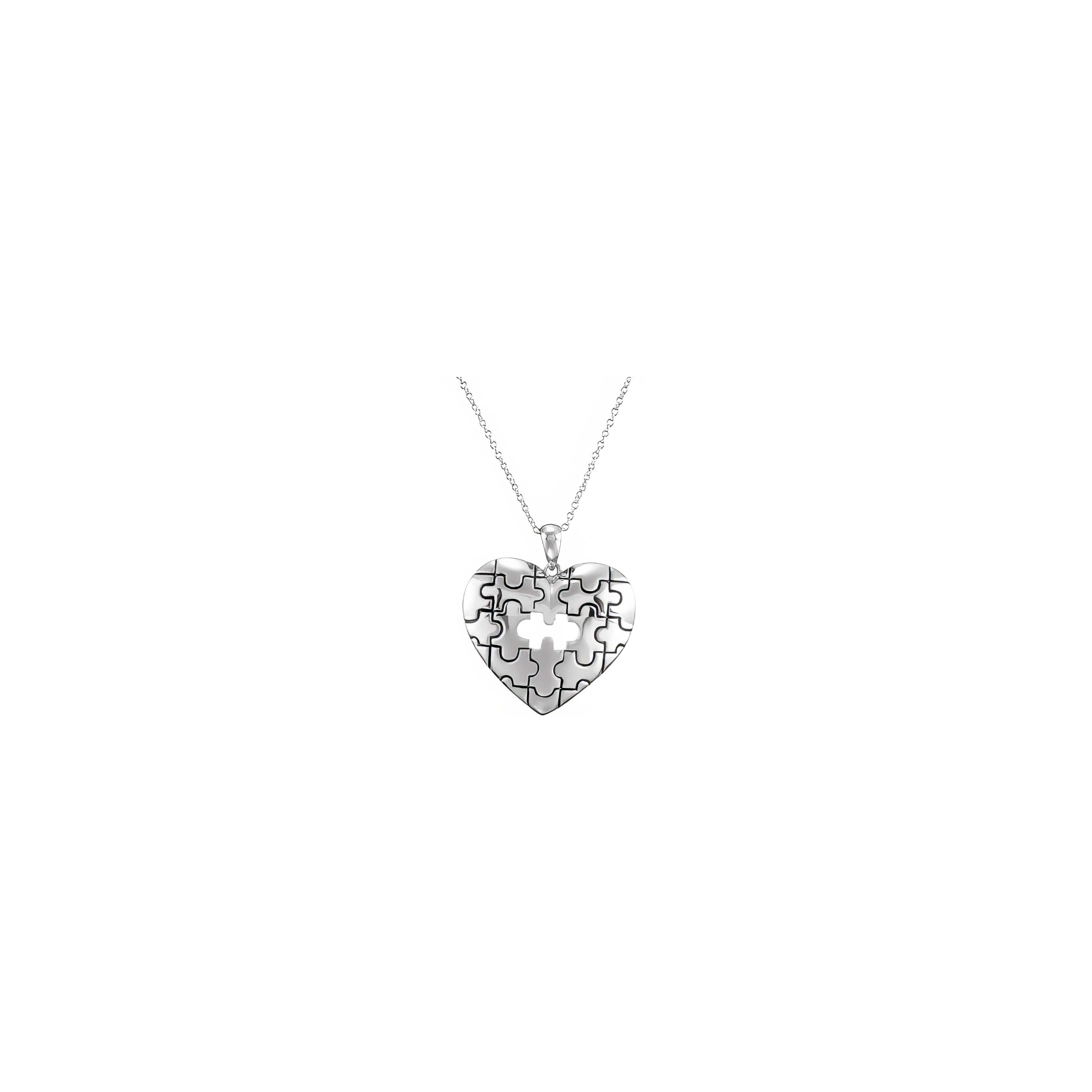 A heart-shaped necklace with a puzzle piece design hangs elegantly on a delicate chain.