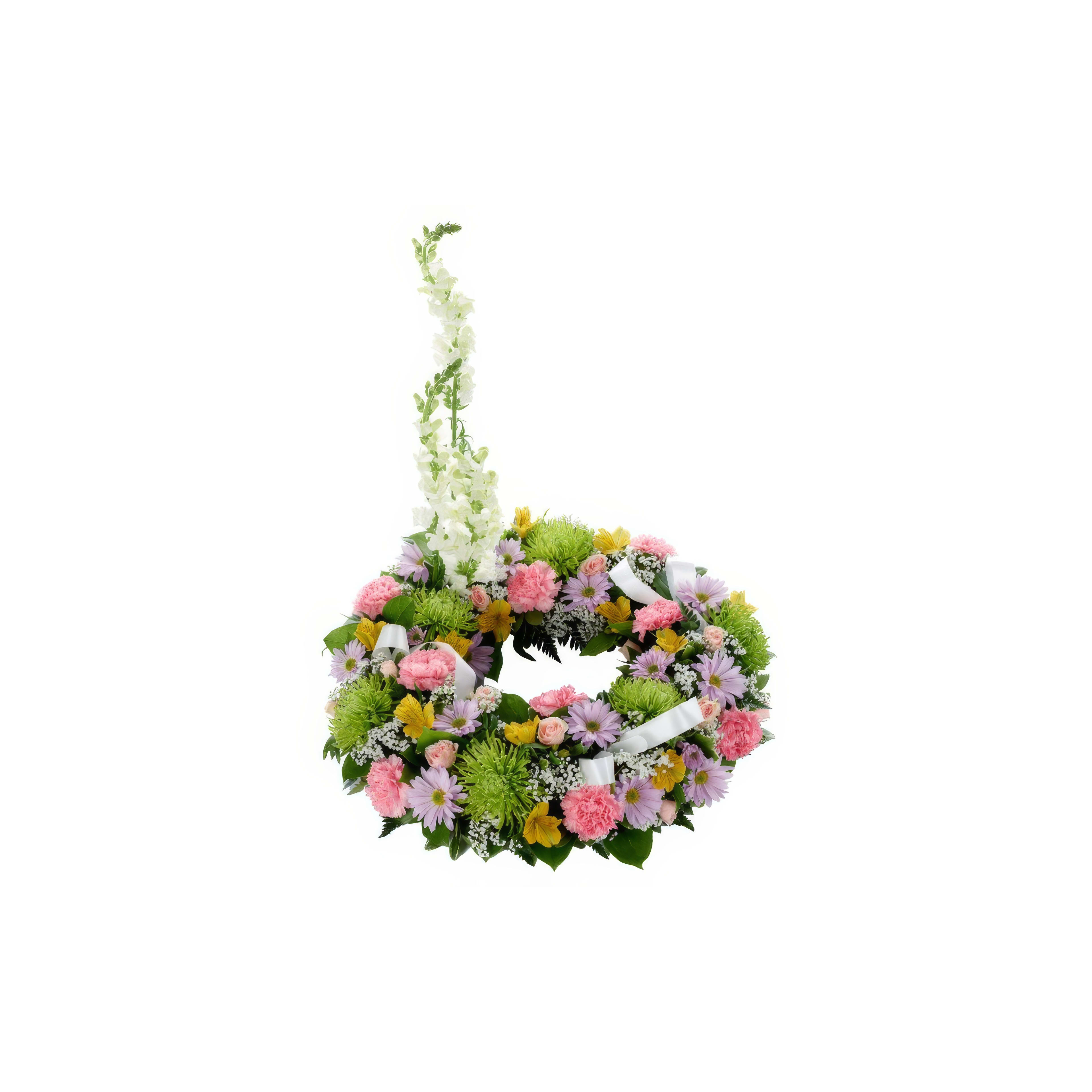 A colorful floral wreath featuring pink, purple, and white flowers adorns a memorial setting.