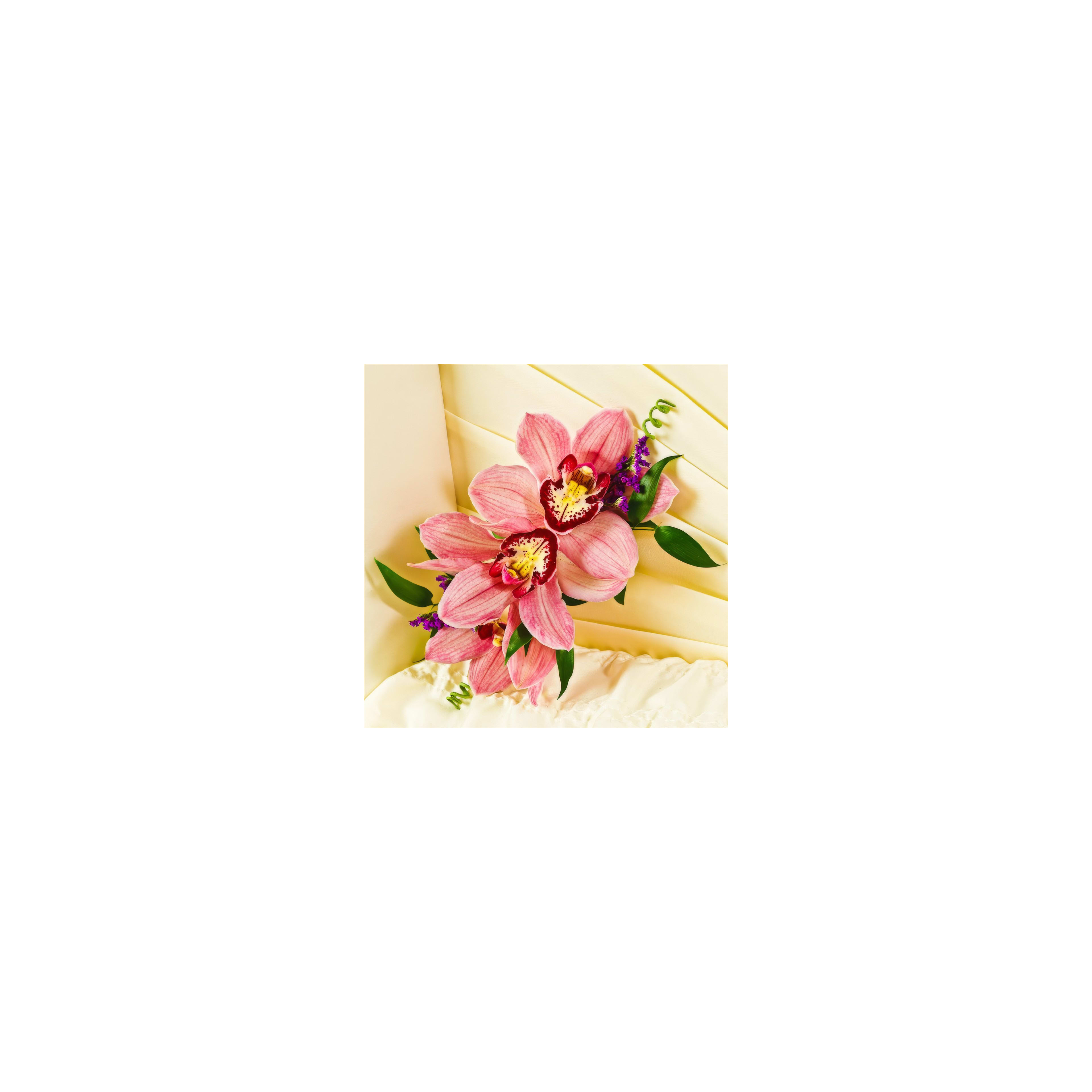 Delicate pink orchids are artfully placed on a creamy cake, enhancing the festive atmosphere.
