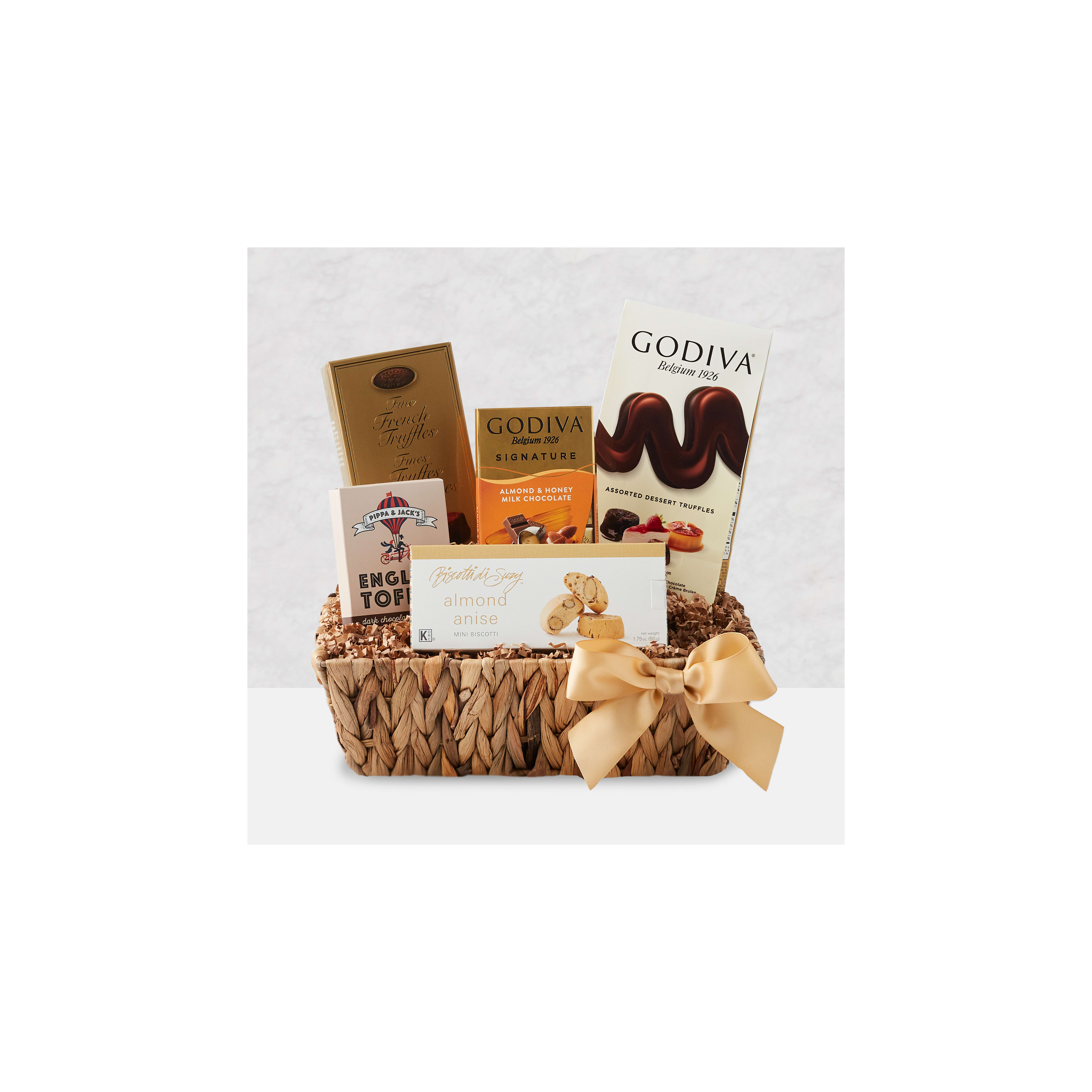 A beautifully arranged gift basket features gourmet chocolates and treats, perfect for celebrations.