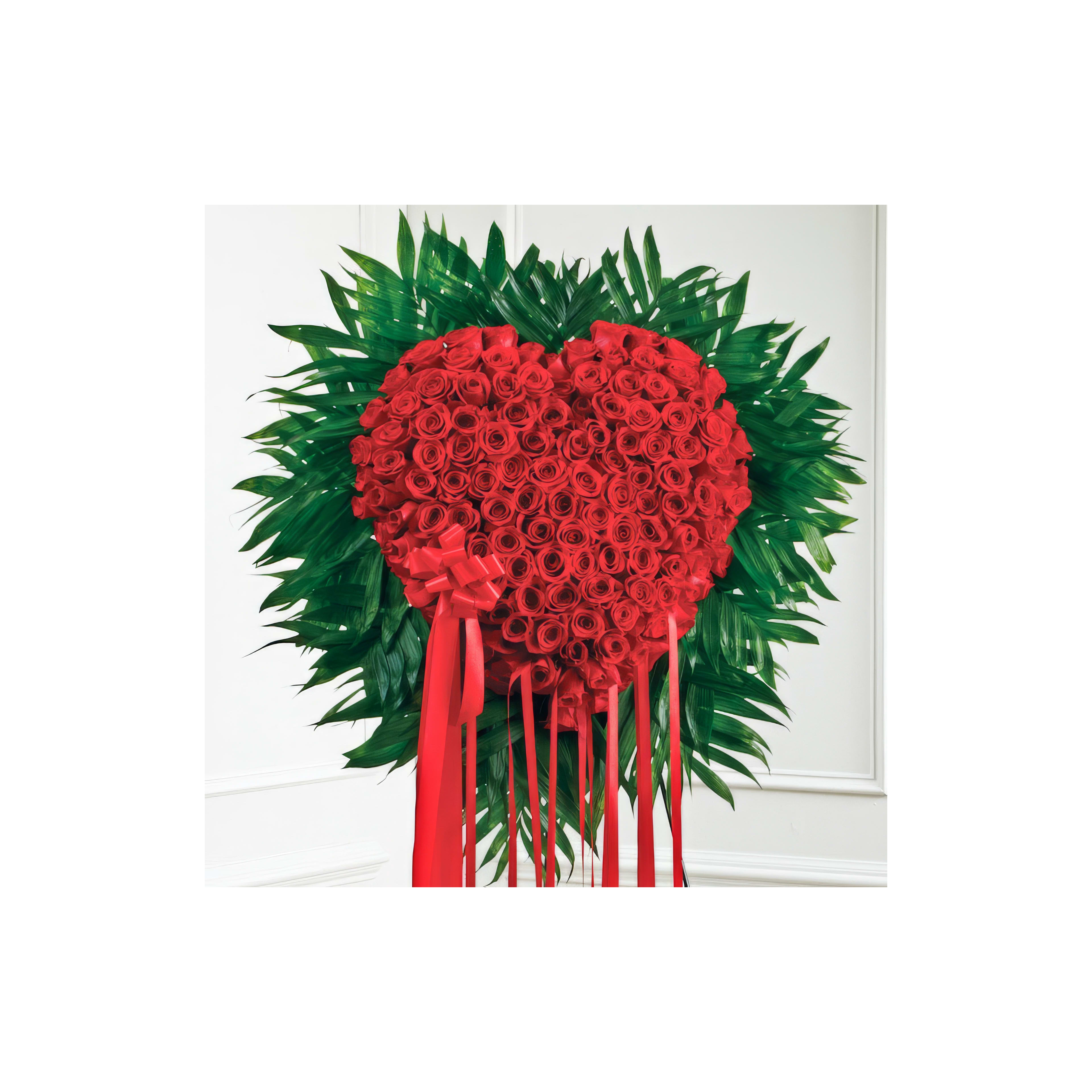 Bright red roses form a heart shape, surrounded by vibrant green leaves, ideal for decorations.