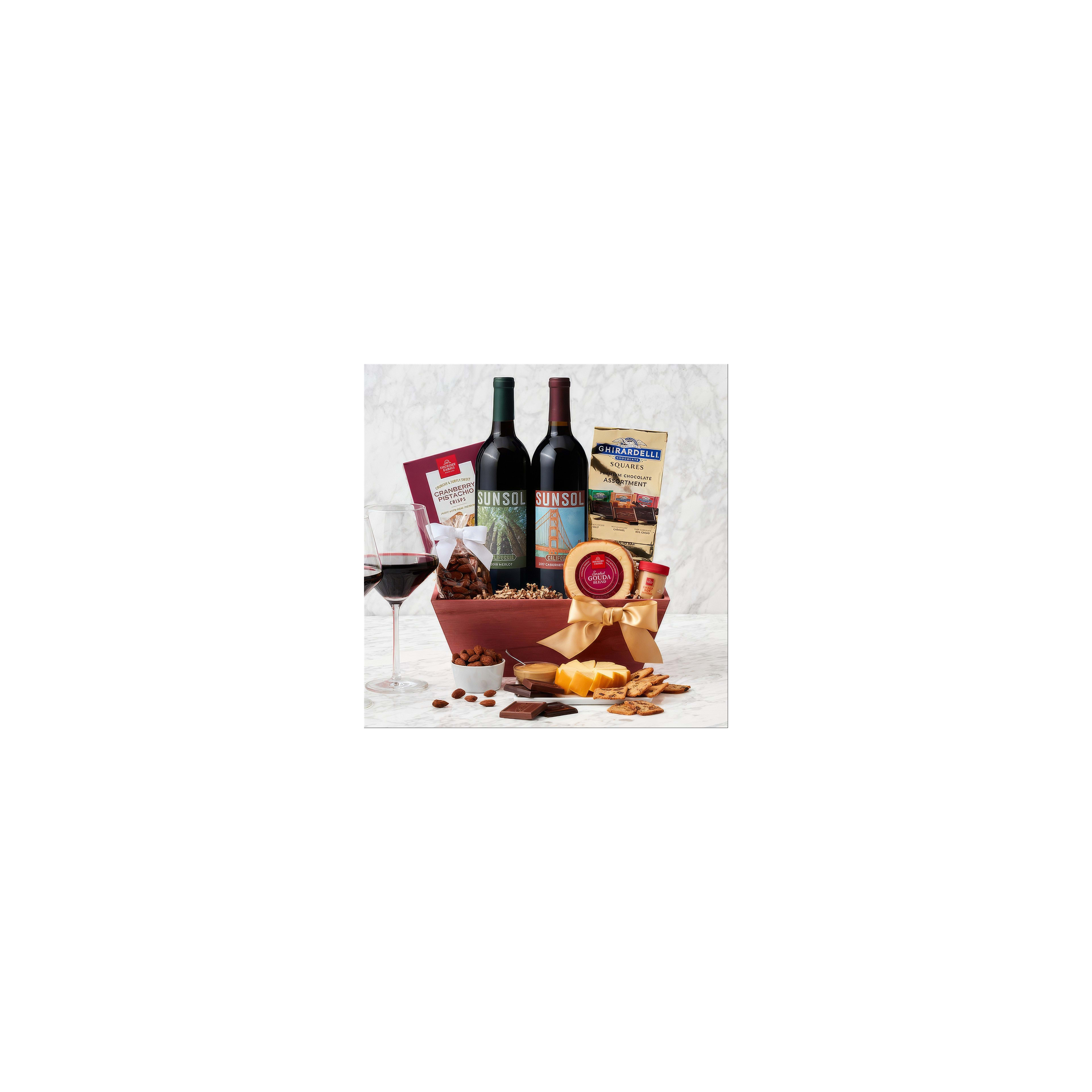 A beautifully arranged gift basket showcases wine, cheese, and tasty snacks for celebration.