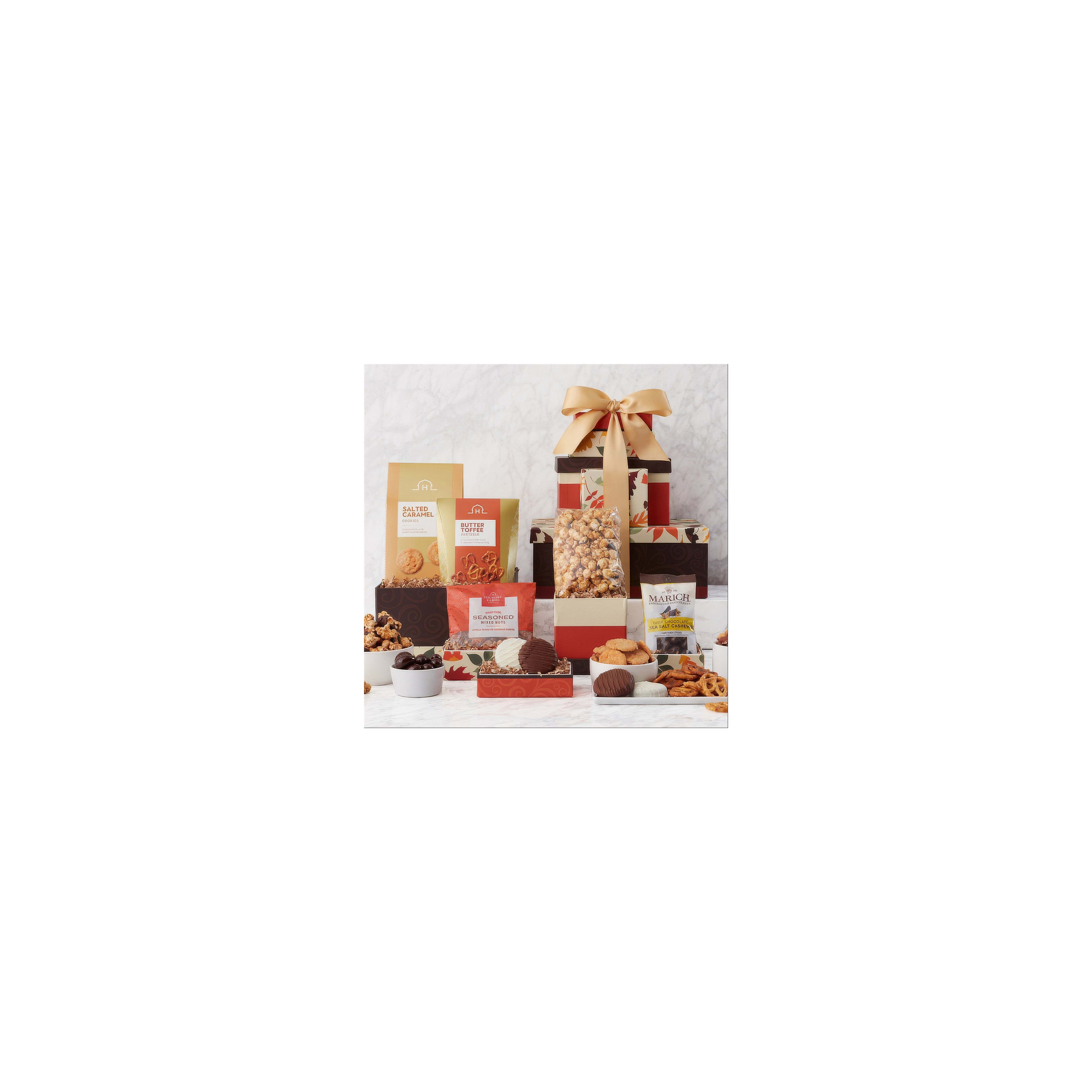 Several beautifully arranged gift boxes overflowing with colorful snacks and sweets are showcased.