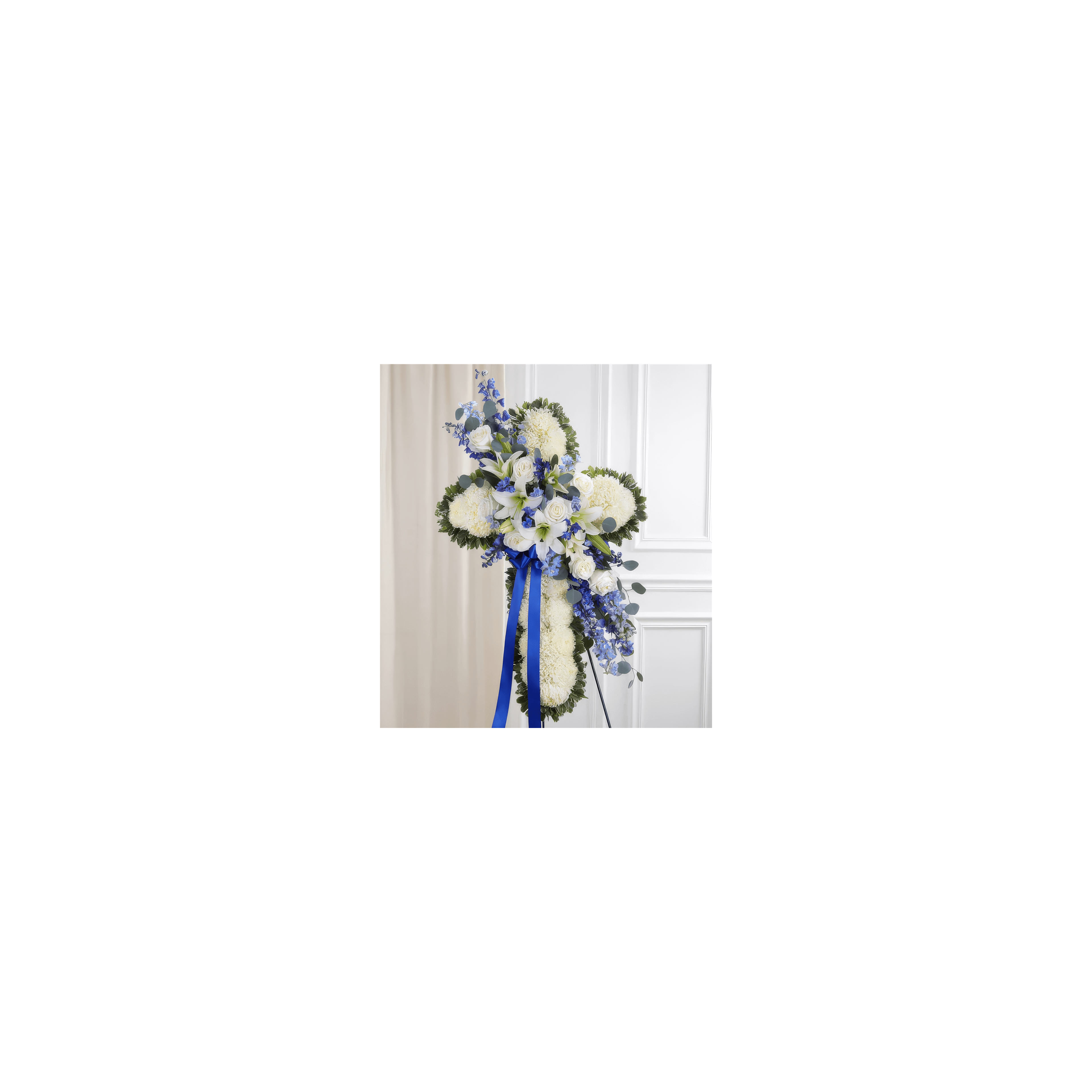 Beautifully arranged cross made of white flowers and blue accents for a solemn occasion.