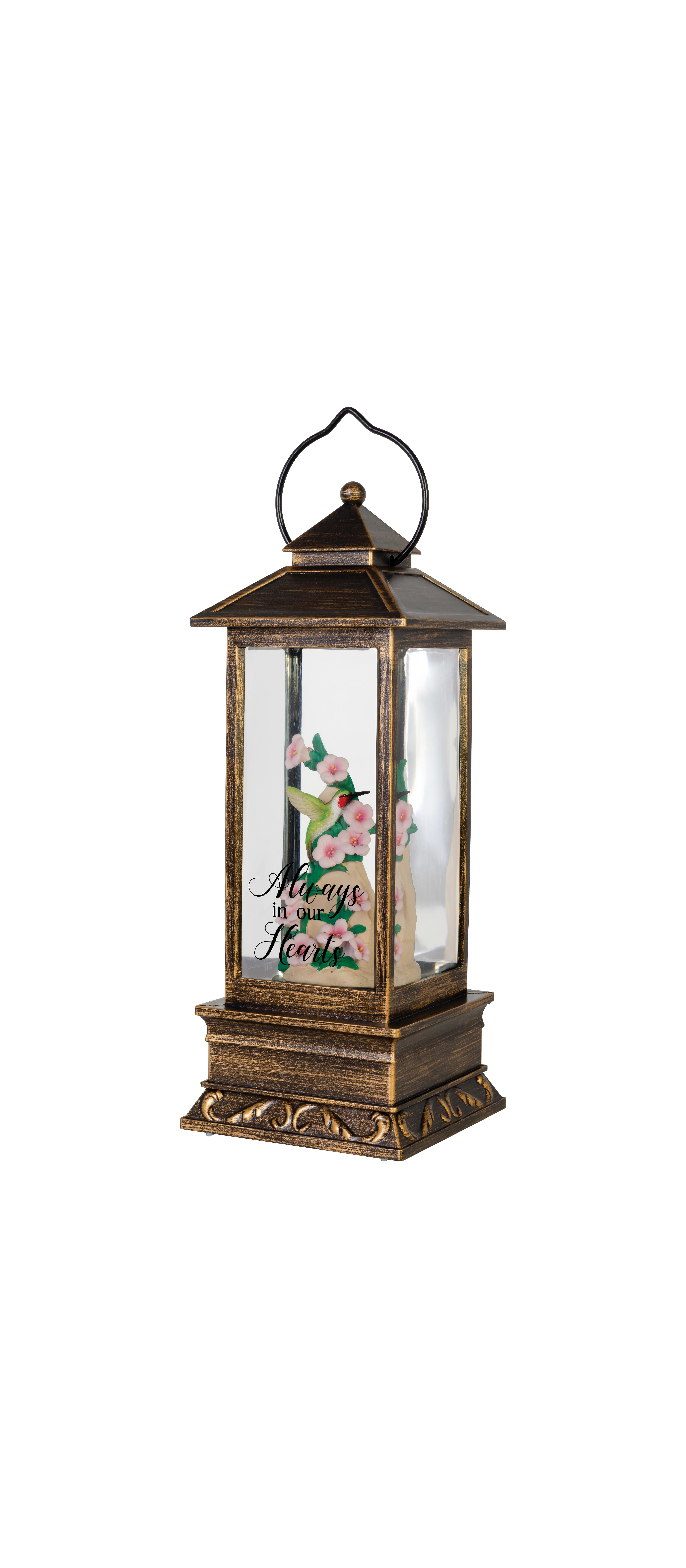 A decorative lantern showcases delicate pink flowers alongside an inspiring message about love.
