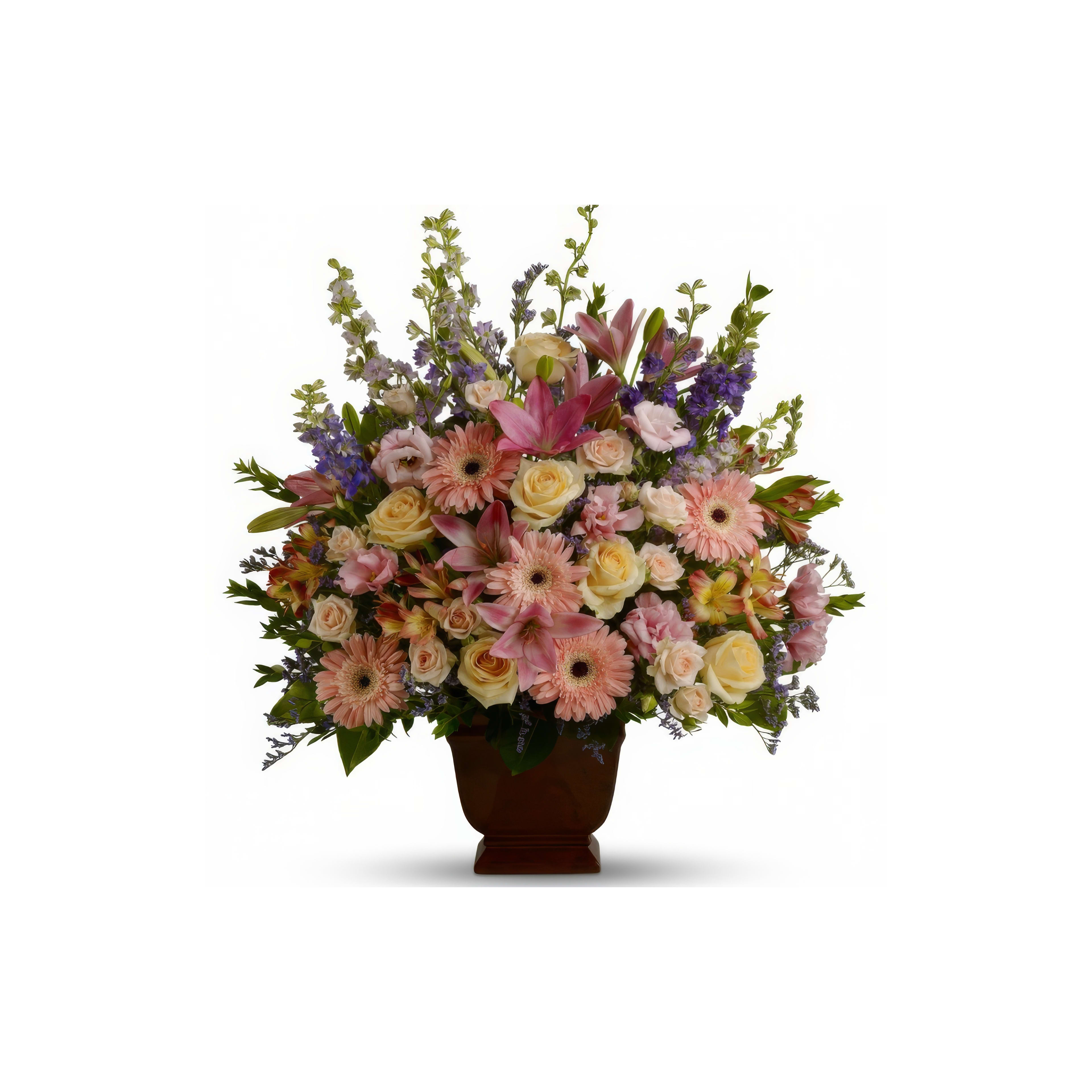 A beautiful floral arrangement features a variety of colorful flowers in a decorative vase.