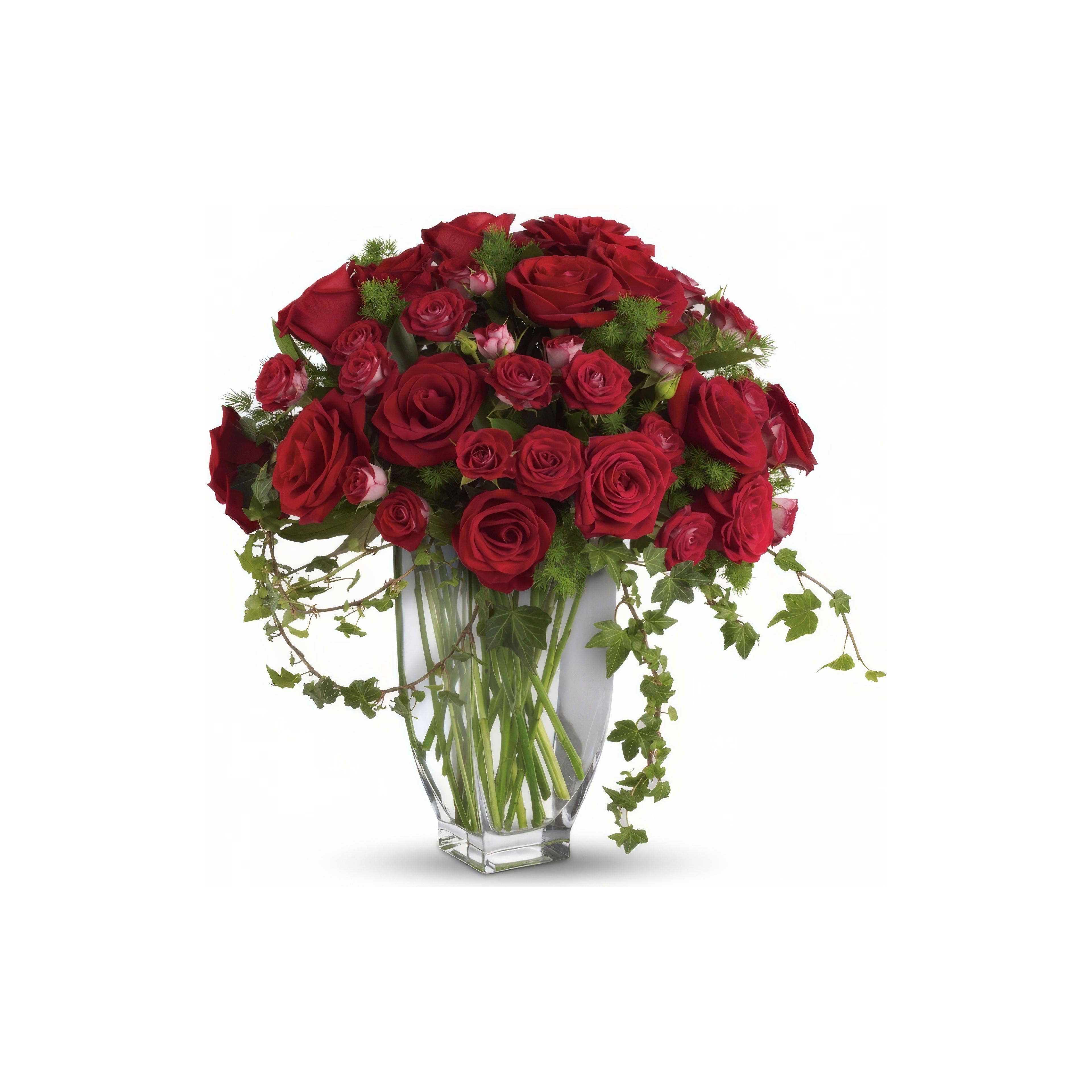 Bright red roses are beautifully arranged in a crystal-clear vase, showcasing elegance and romance.
