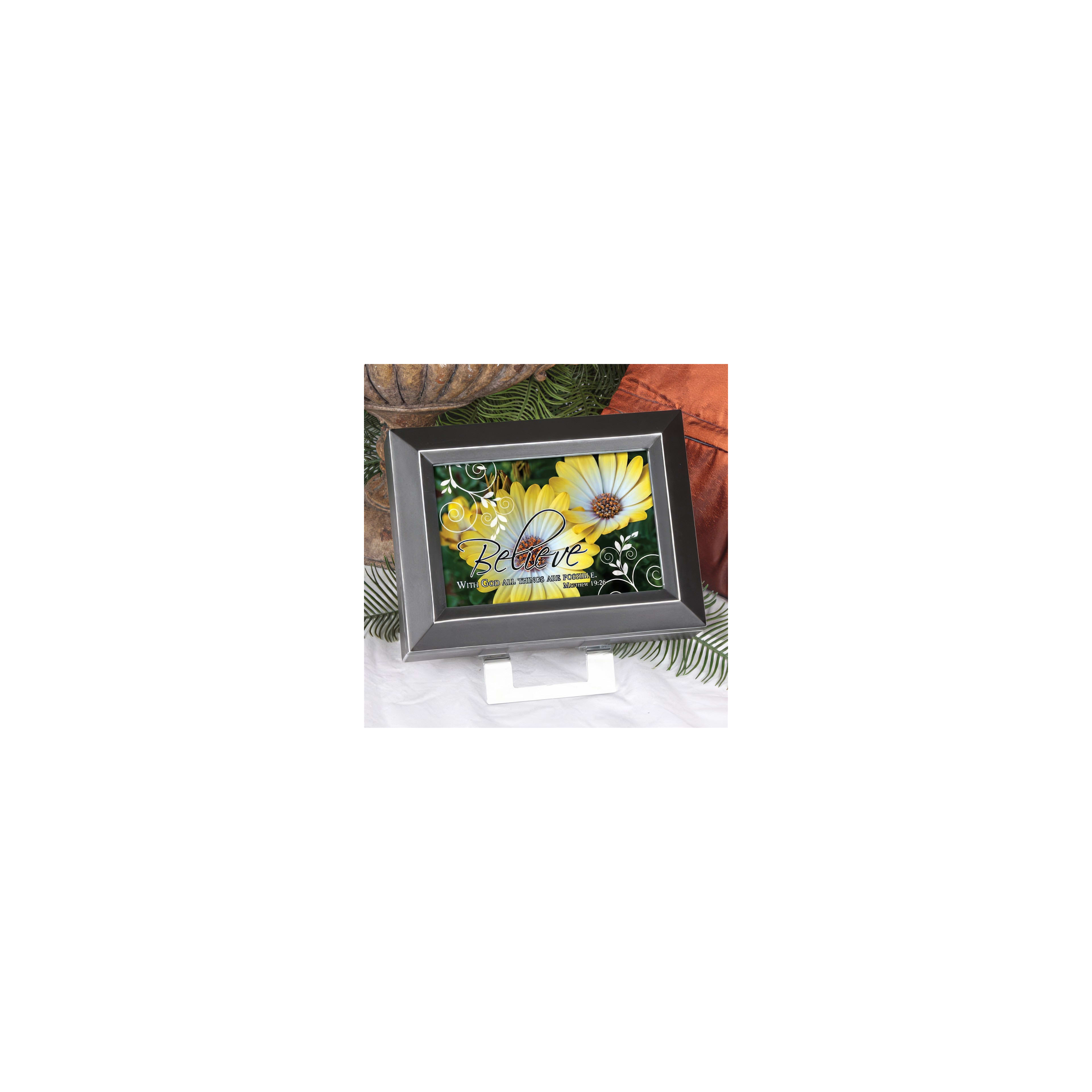 A decorative frame holds cheerful artwork with the word 'Believe' surrounded by bright flowers.
