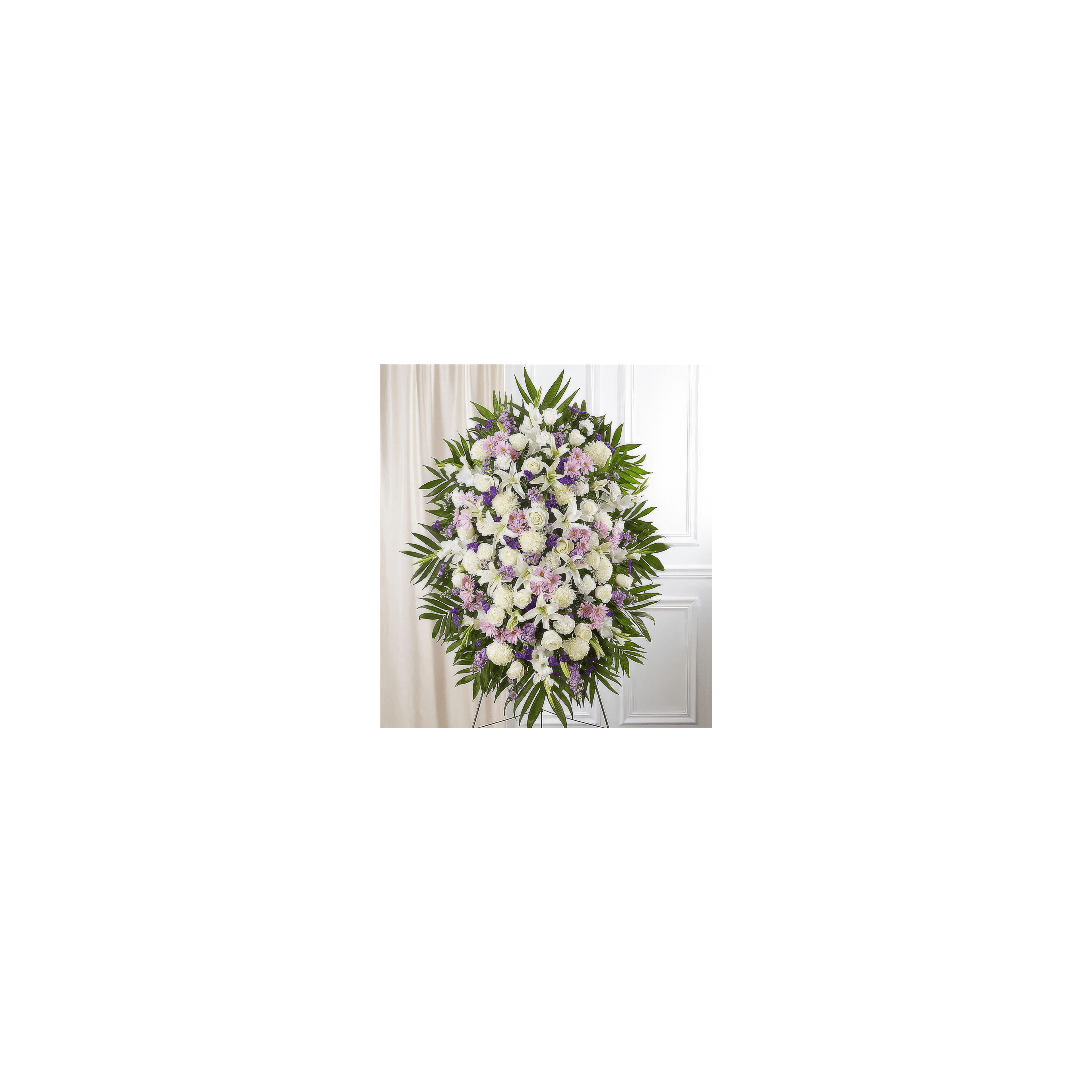A vibrant floral display composed of white and purple flowers adorns a simple indoor setting.