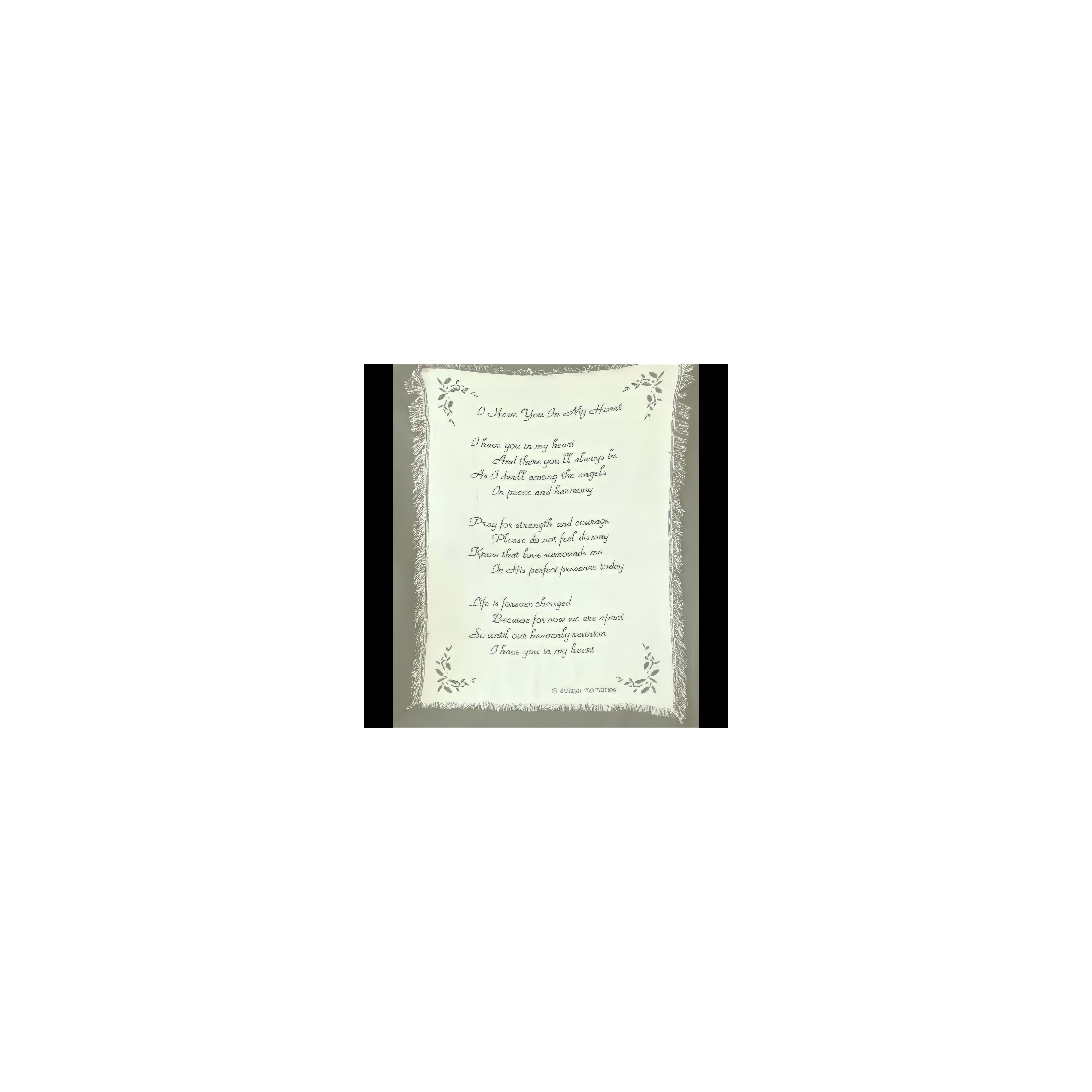 A decorative fabric piece showcases a love poem framed by floral designs.