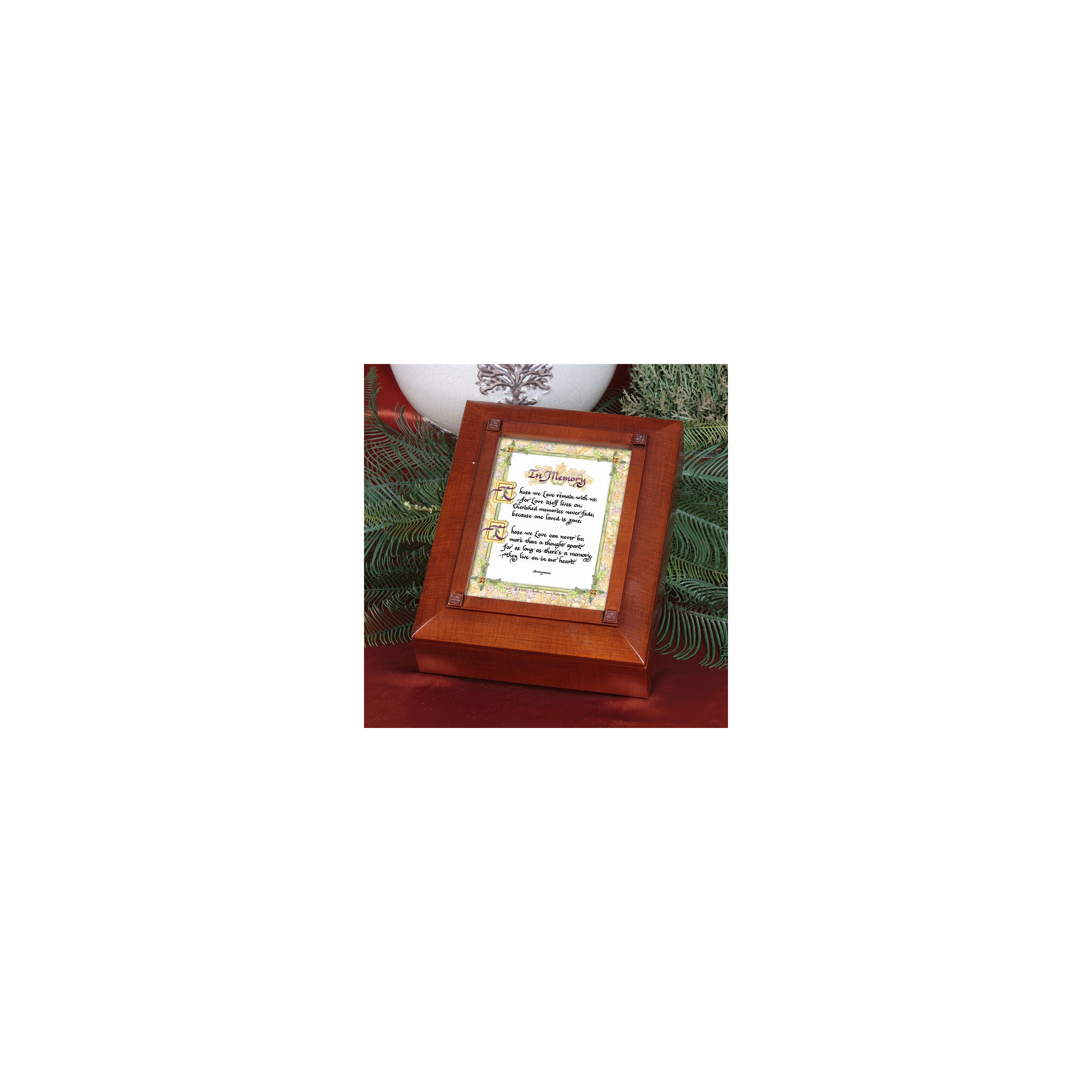 An ornate wooden frame rests on a table adorned with greenery and holiday elements.