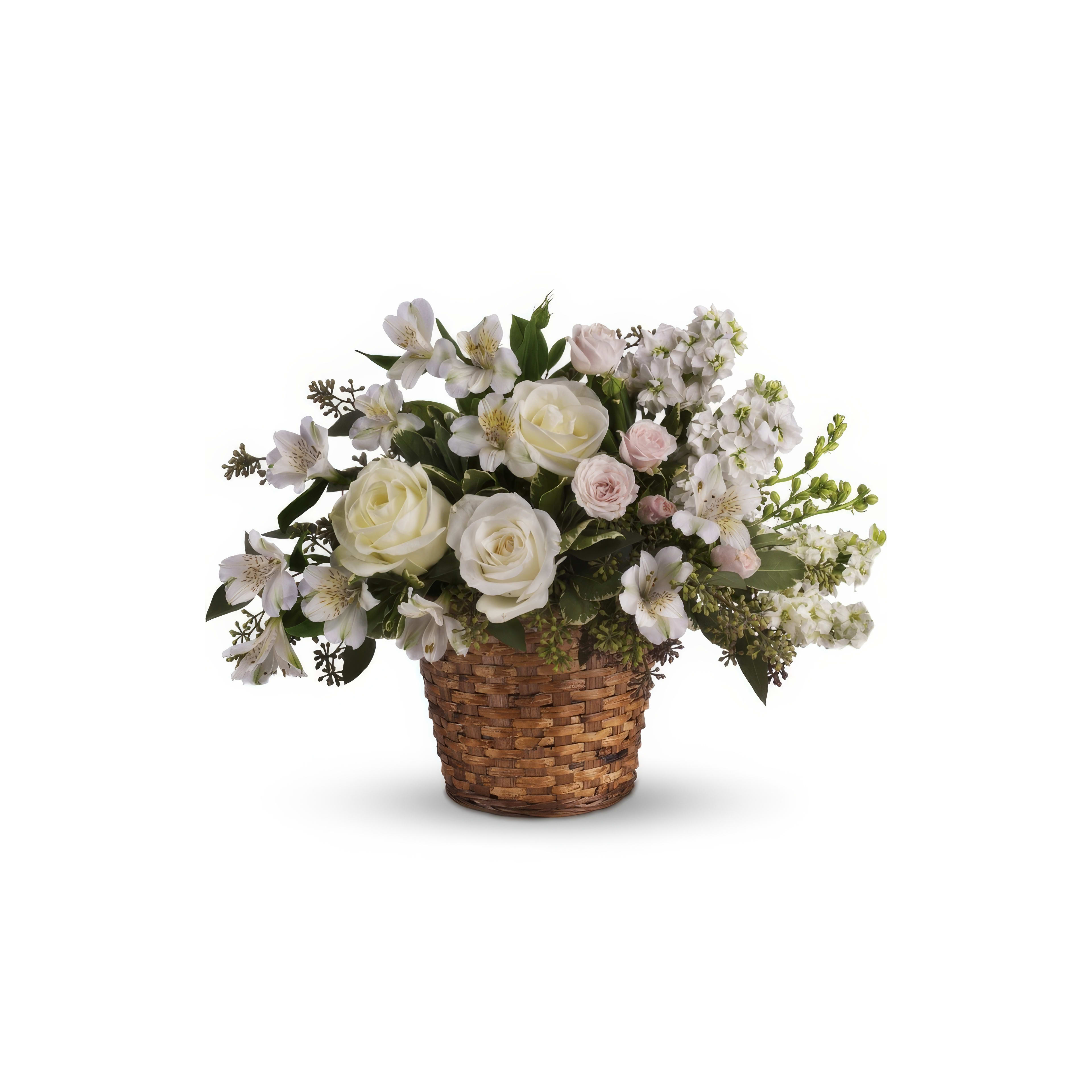Elegant floral display featuring white roses and various flowers in a woven basket.