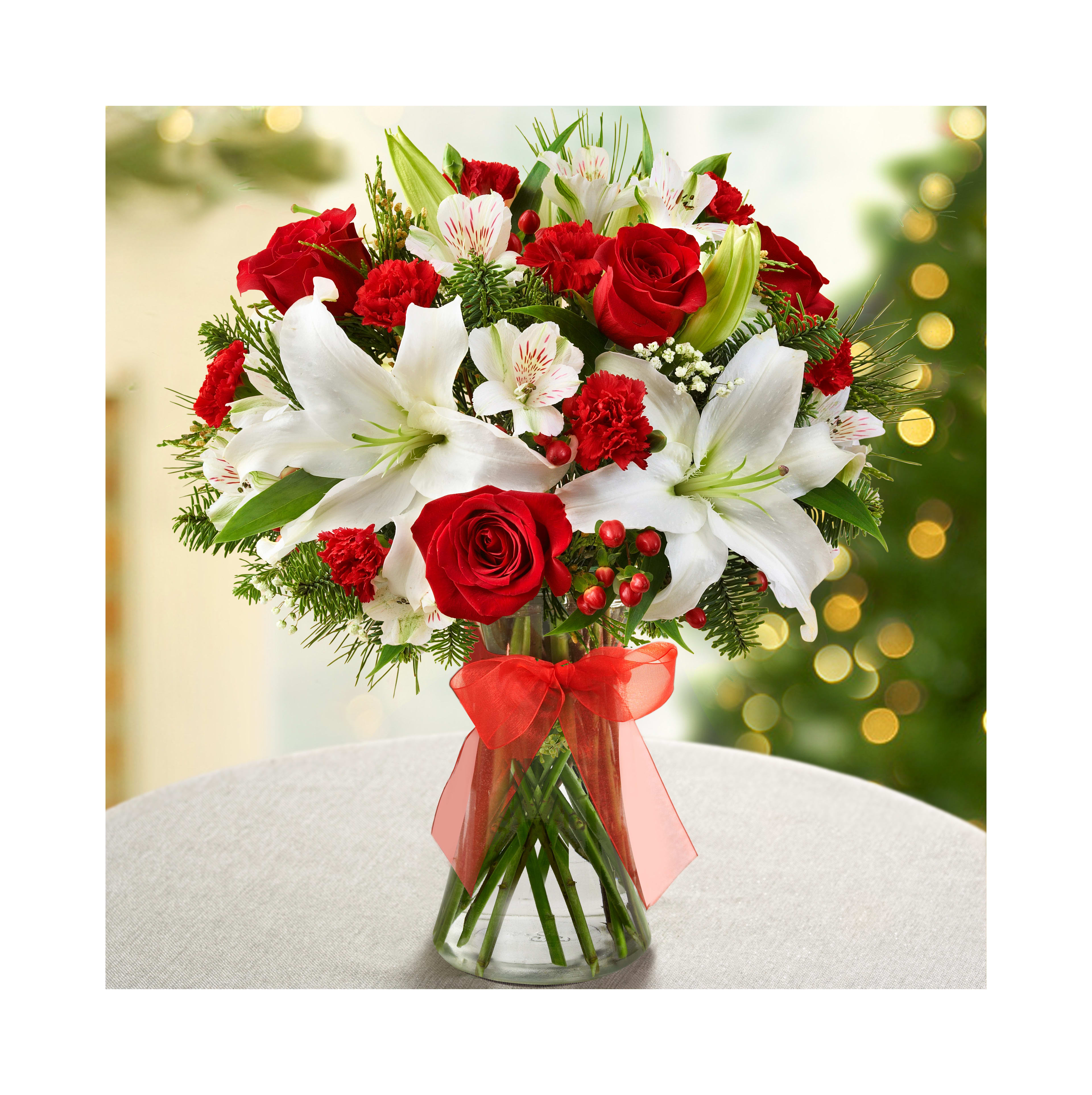 A stunning bouquet of red roses, white lilies, and lush greenery for a festive occasion.