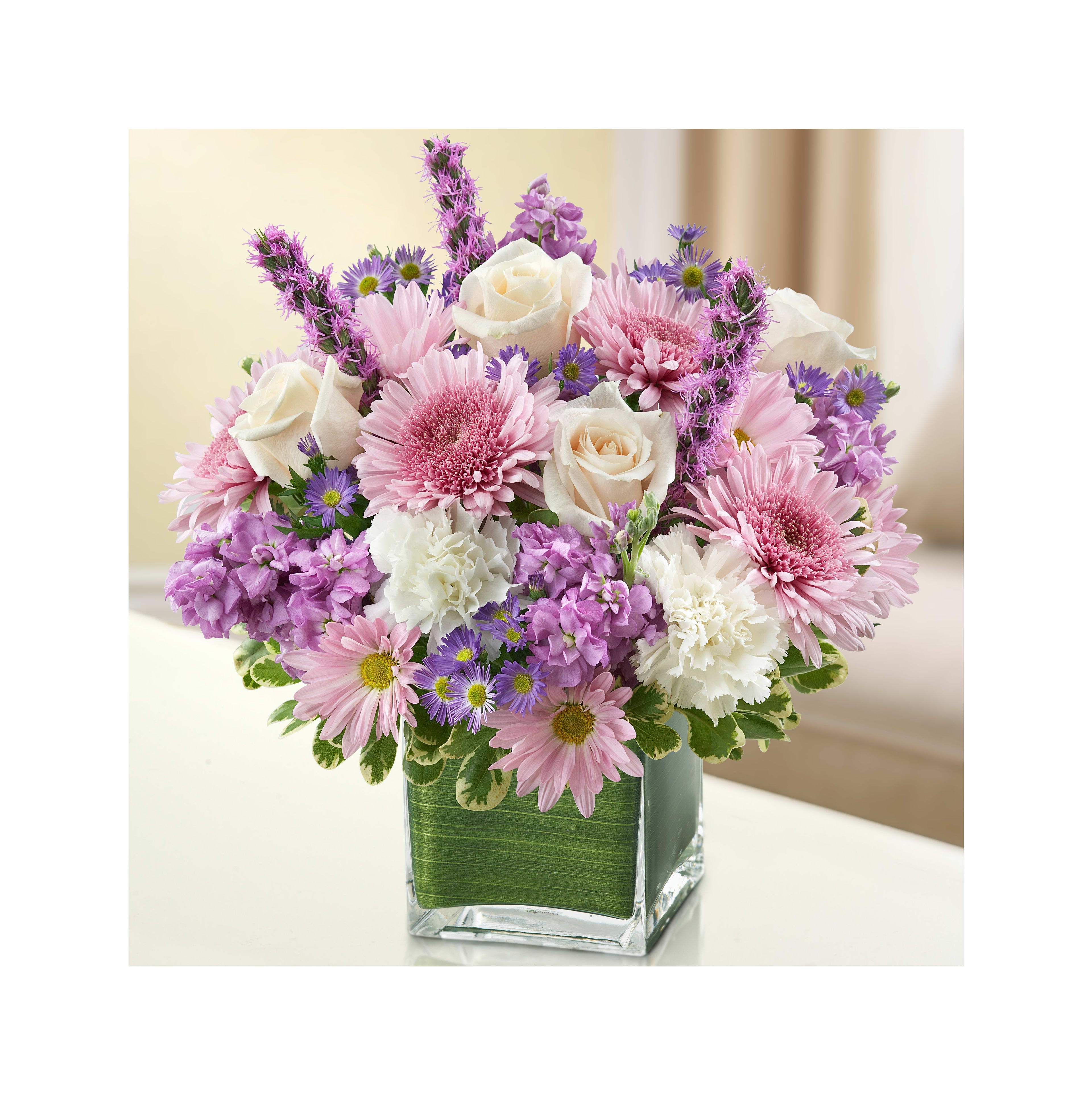 Vibrant pink and white flower bouquet in a stylish glass vase for celebrations.