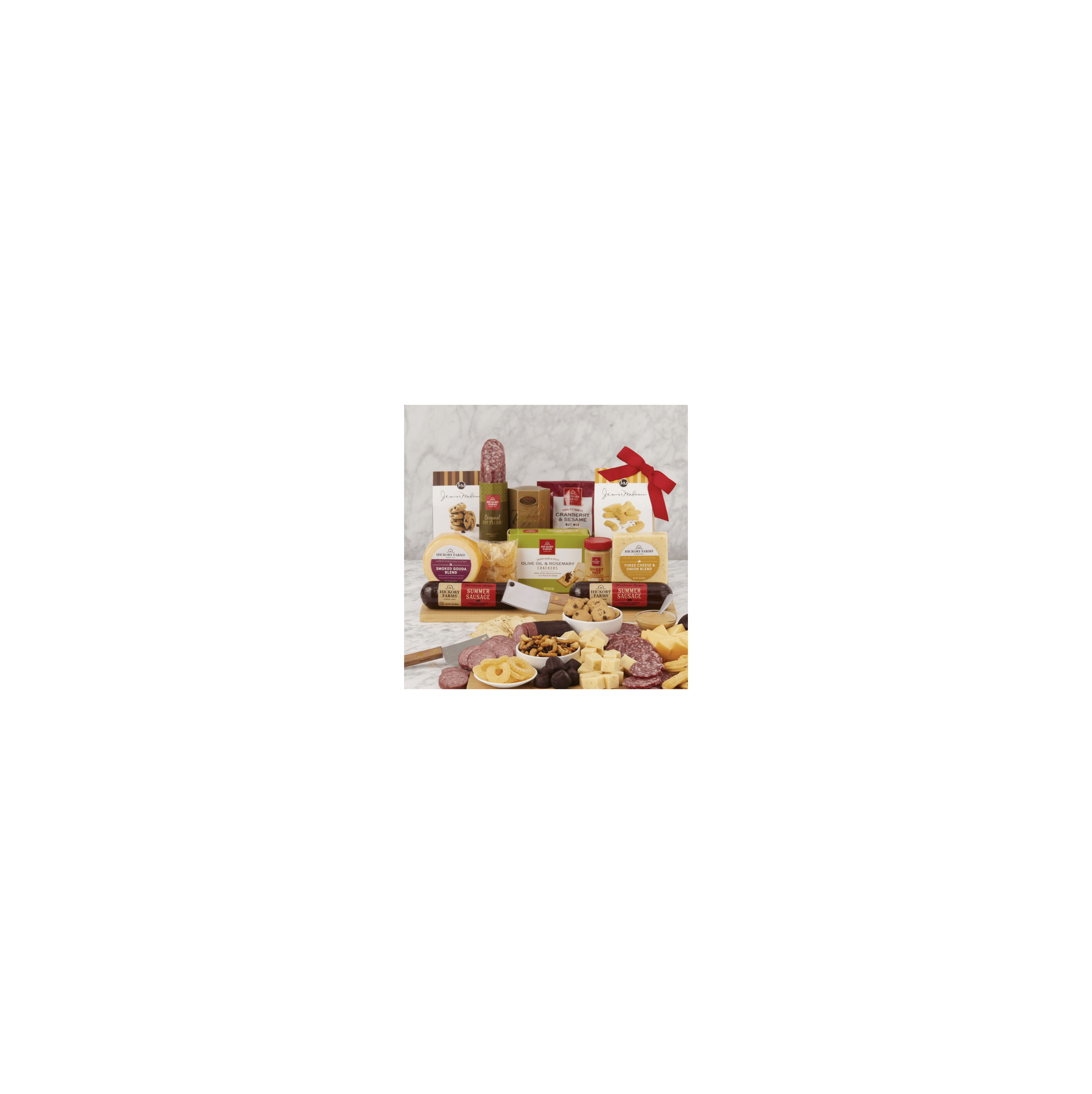 A colorful display of meats, cheeses, and sweet treats on a marble surface delights the senses.