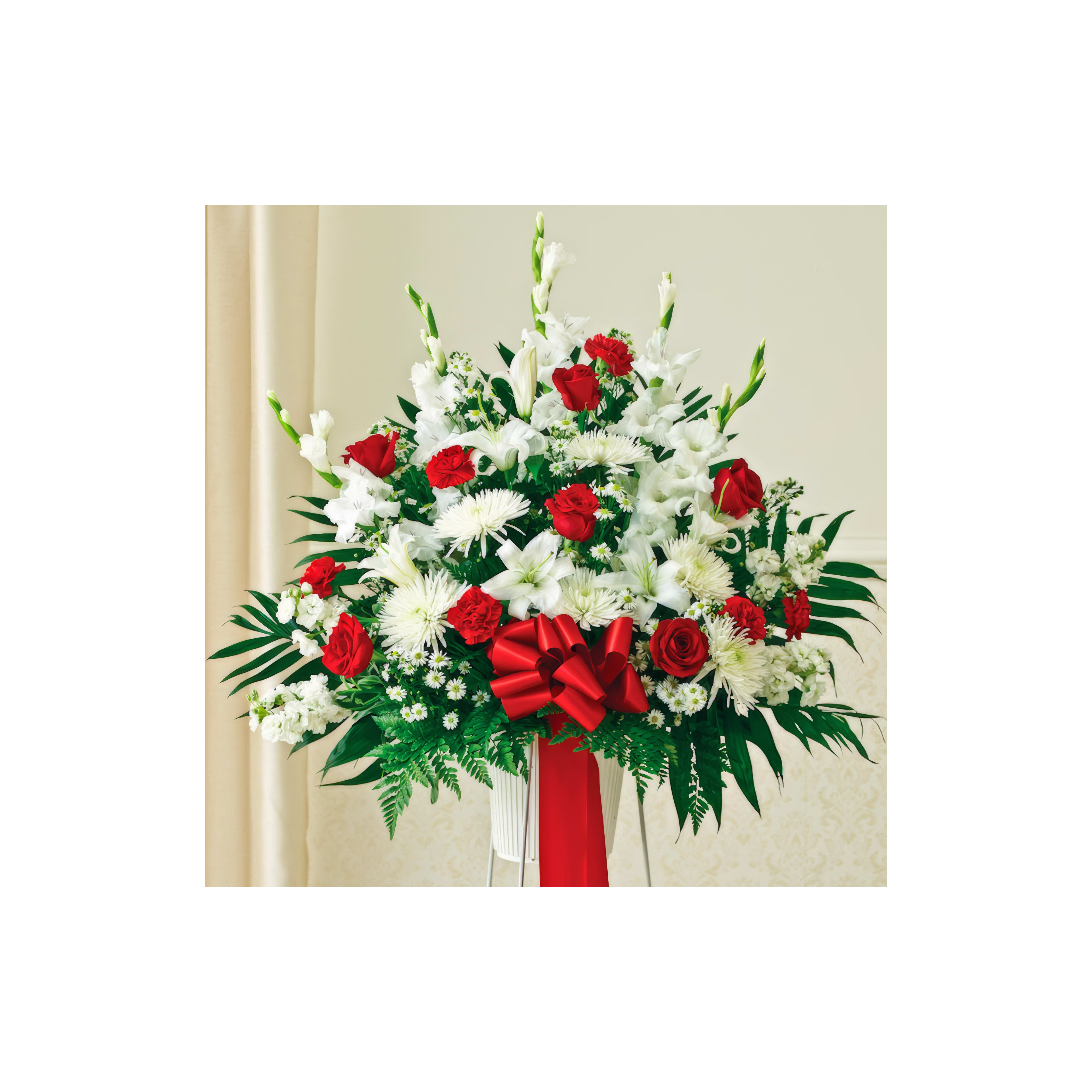Colorful floral display featuring red roses, white lilies, and greenery, perfect for celebrations.