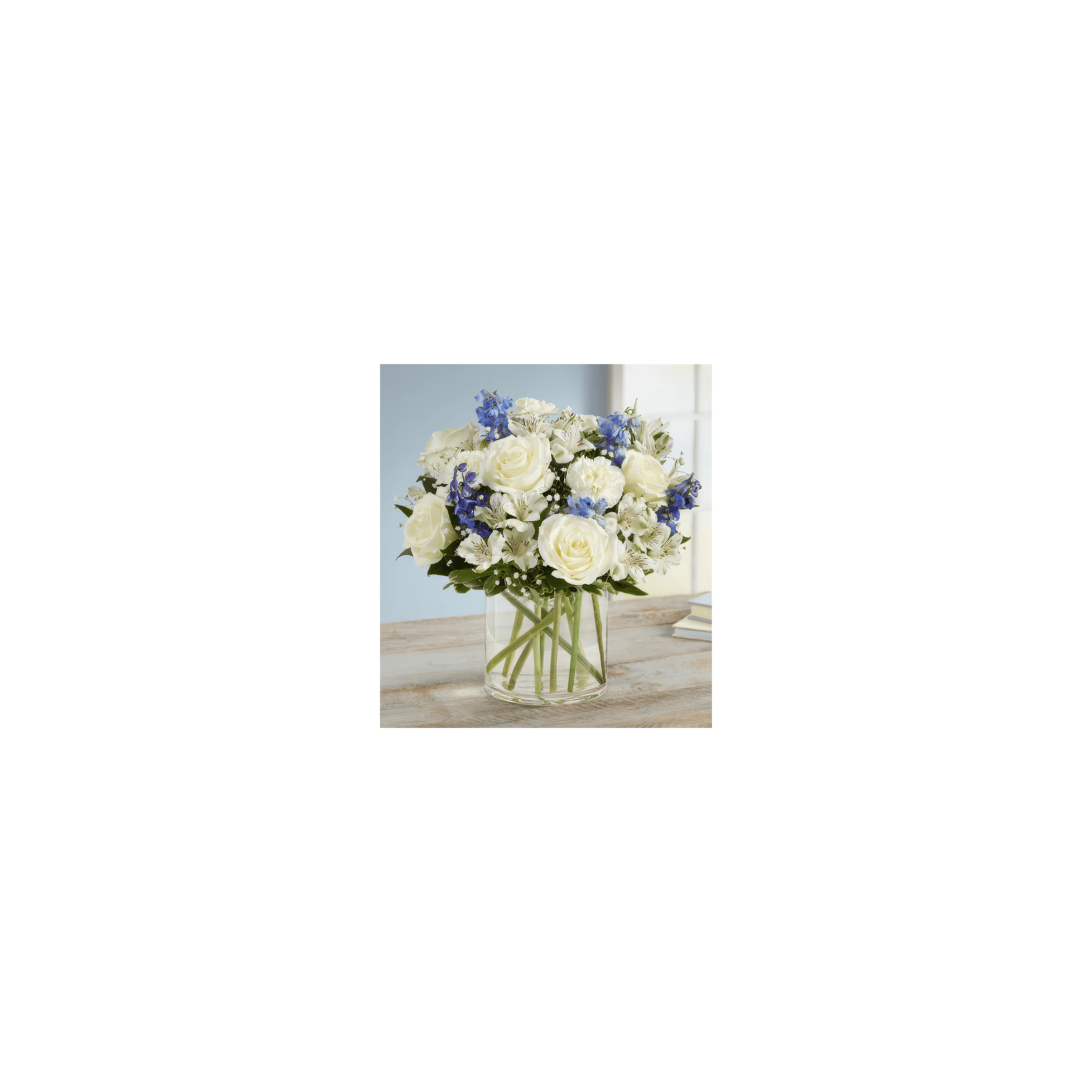 A vibrant bouquet of white roses and blue flowers brightens up a light-filled room.