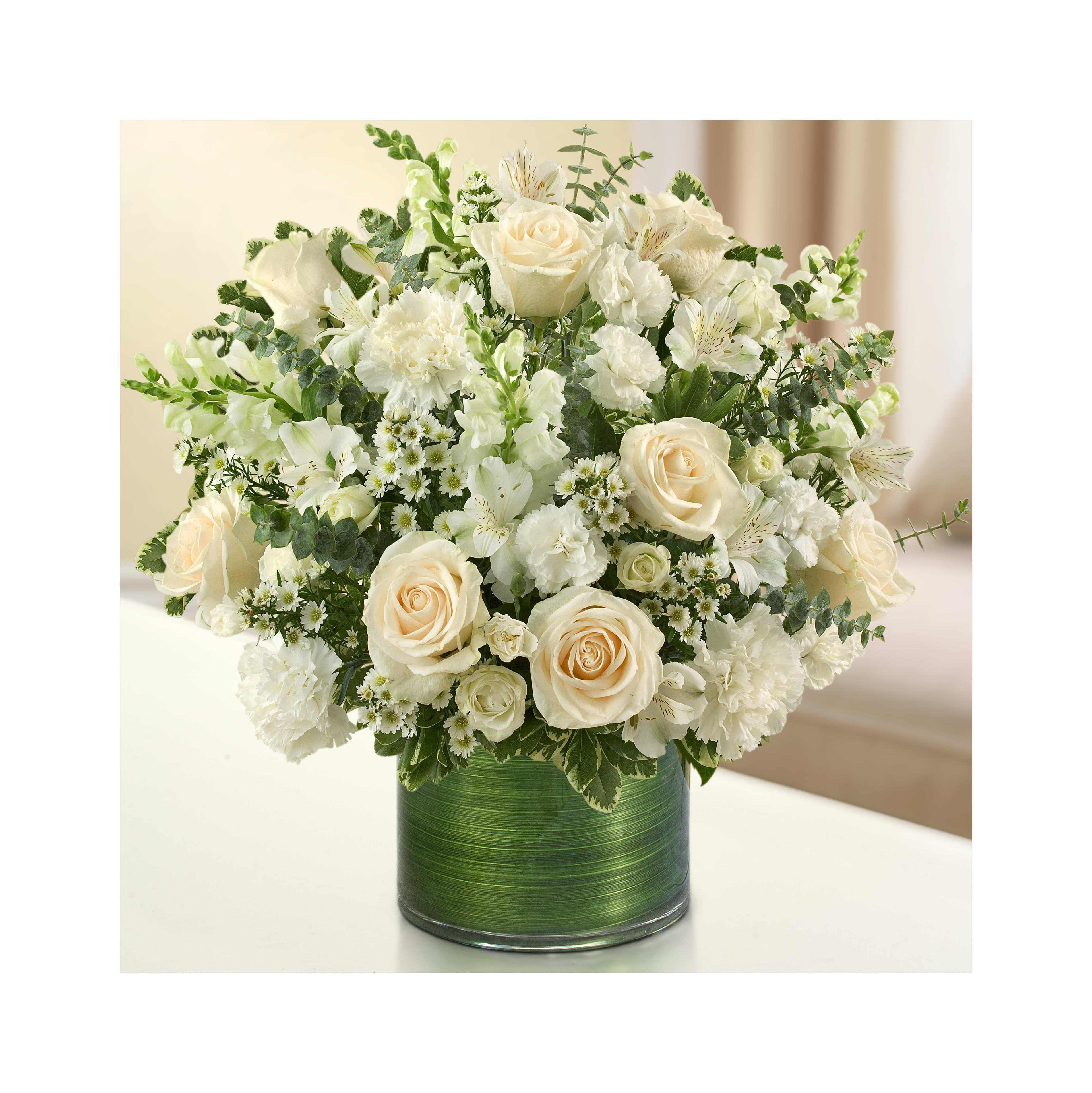 Elegantly arranged white flowers including roses, carnations, and greenery in a glass vase.