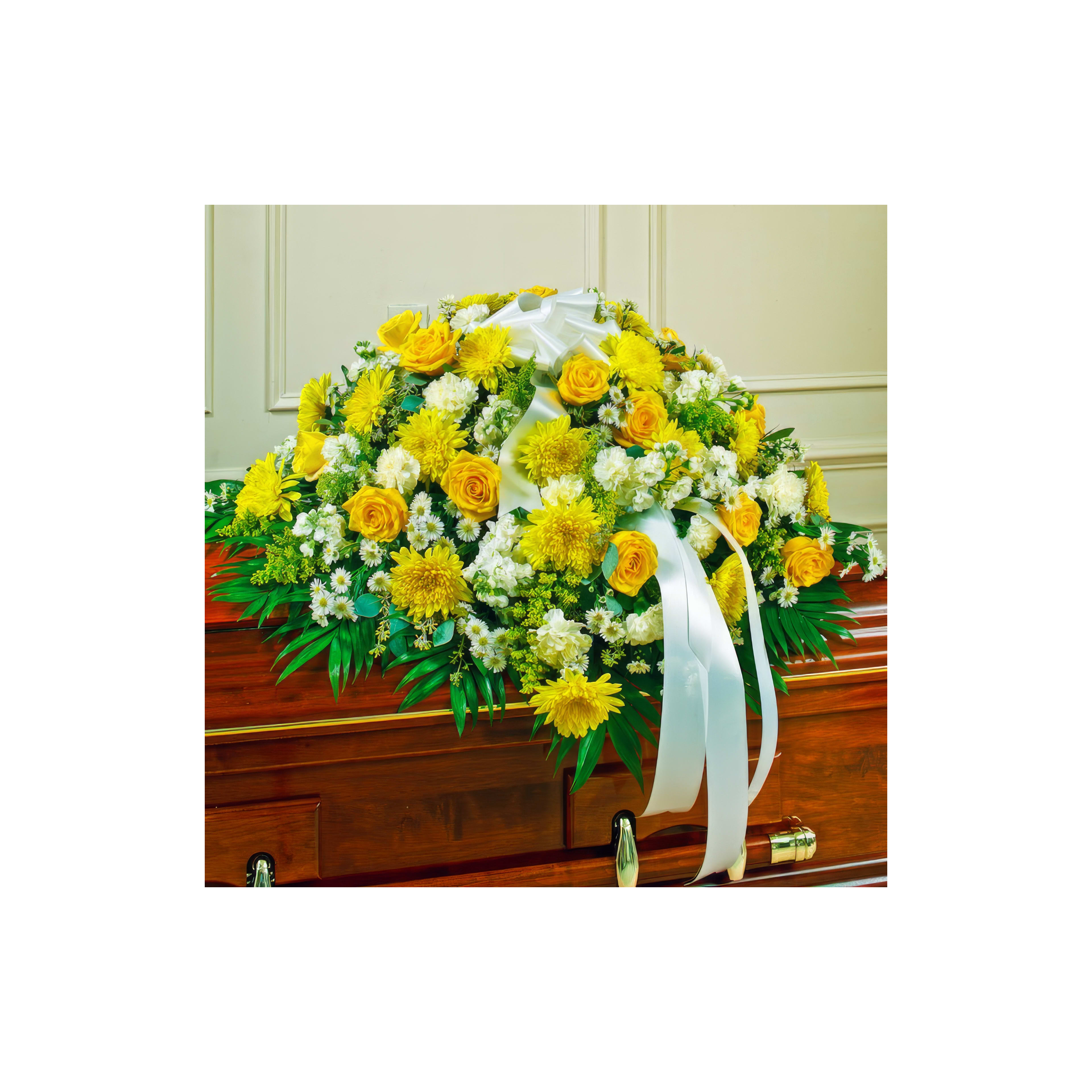 Bright yellow and white flowers beautifully decorate a casket during a memorial gathering.