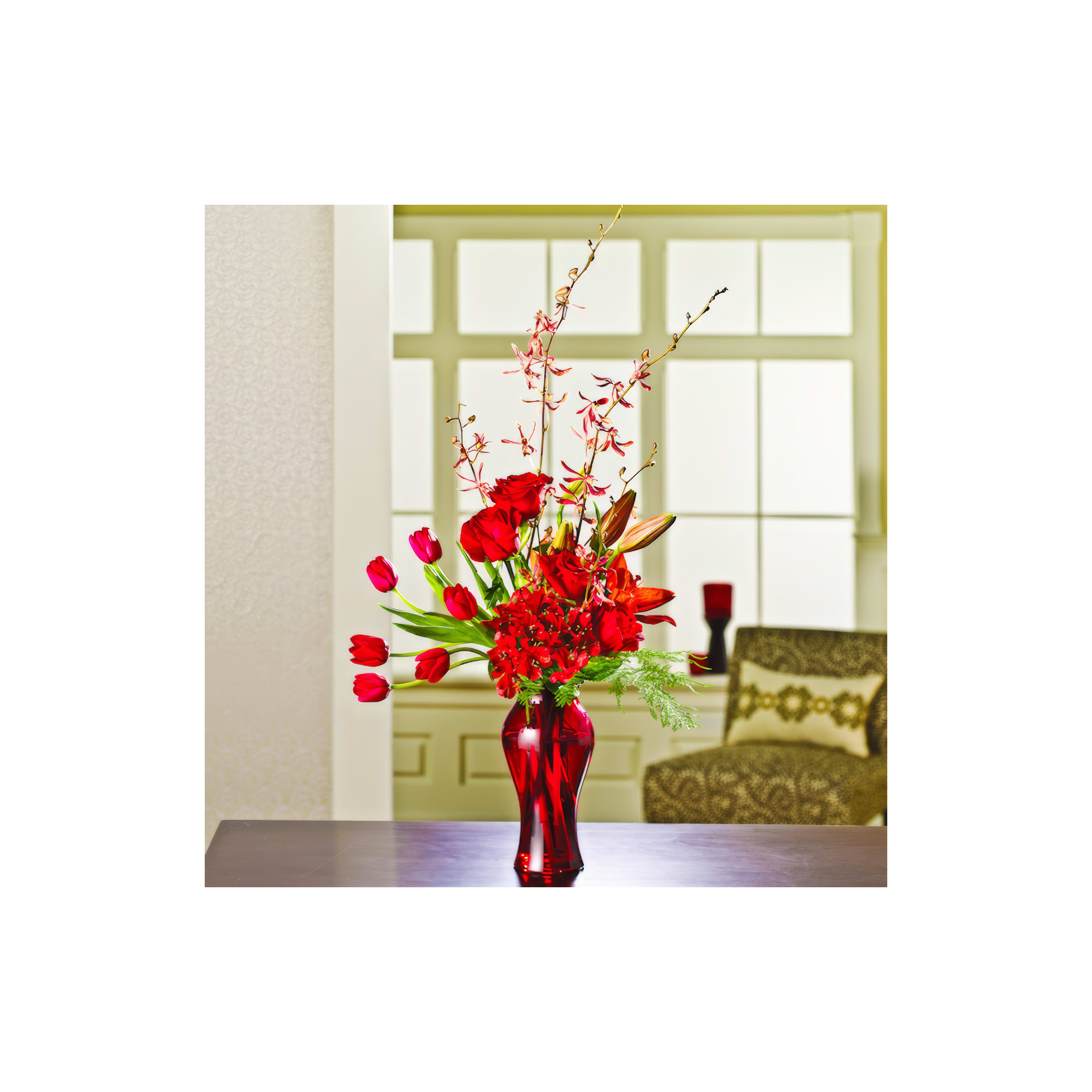 A stunning bouquet of red blooms stands in a vibrant vase, brightening a warm indoor space.