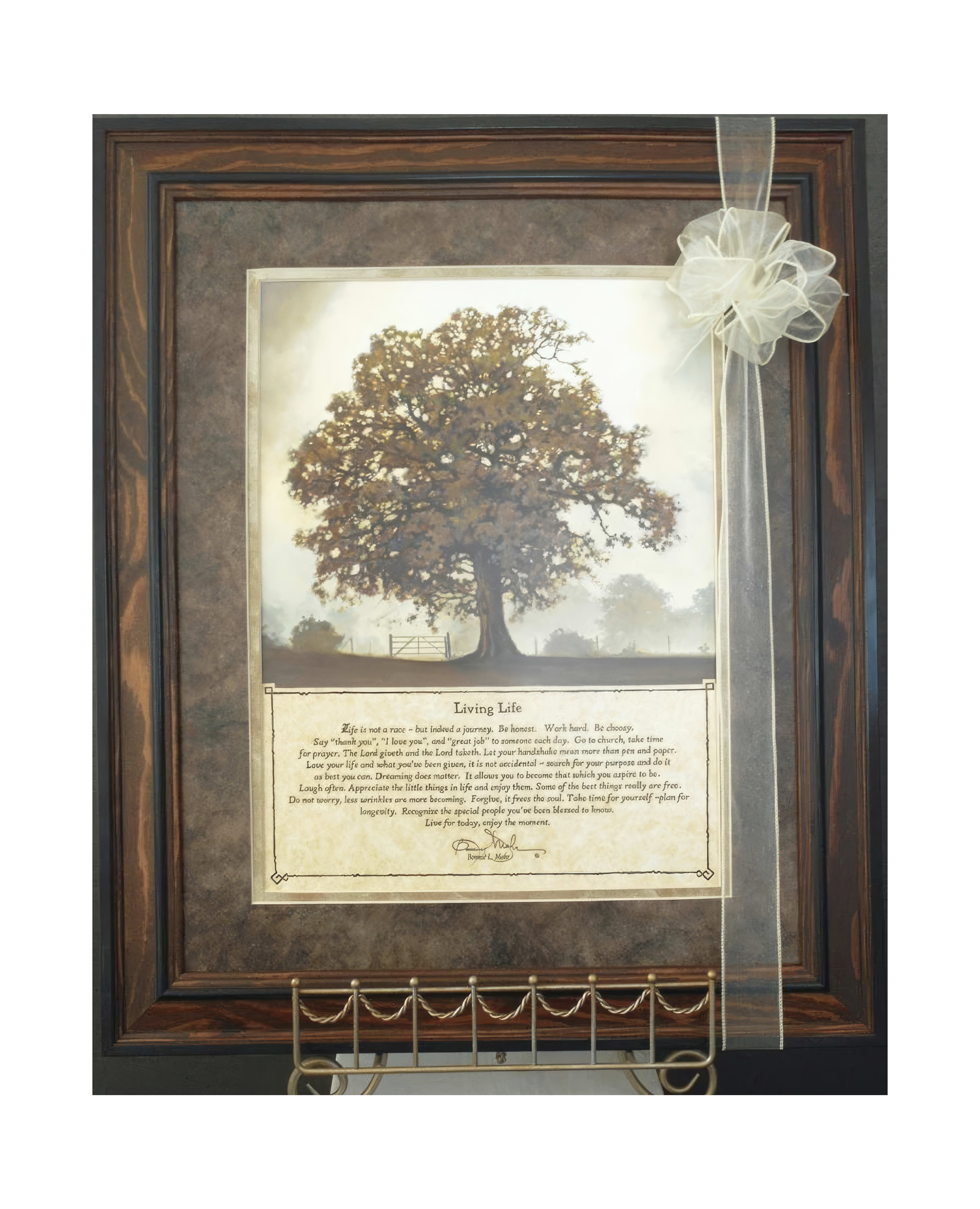A detailed framed artwork features a majestic tree and thoughtful text about living life fully.