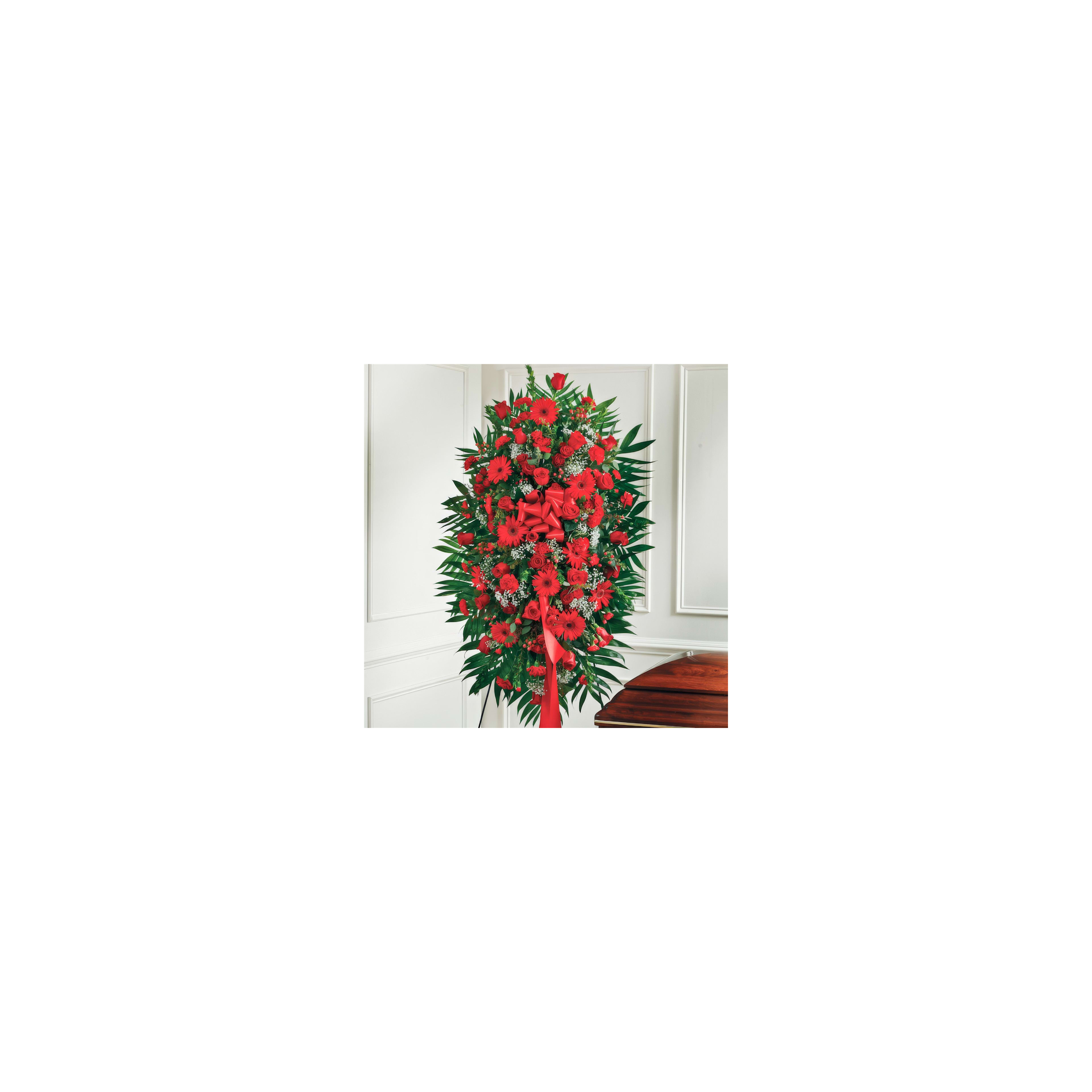 Vibrant red flowers and lush green leaves create a stunning indoor display for a celebration.
