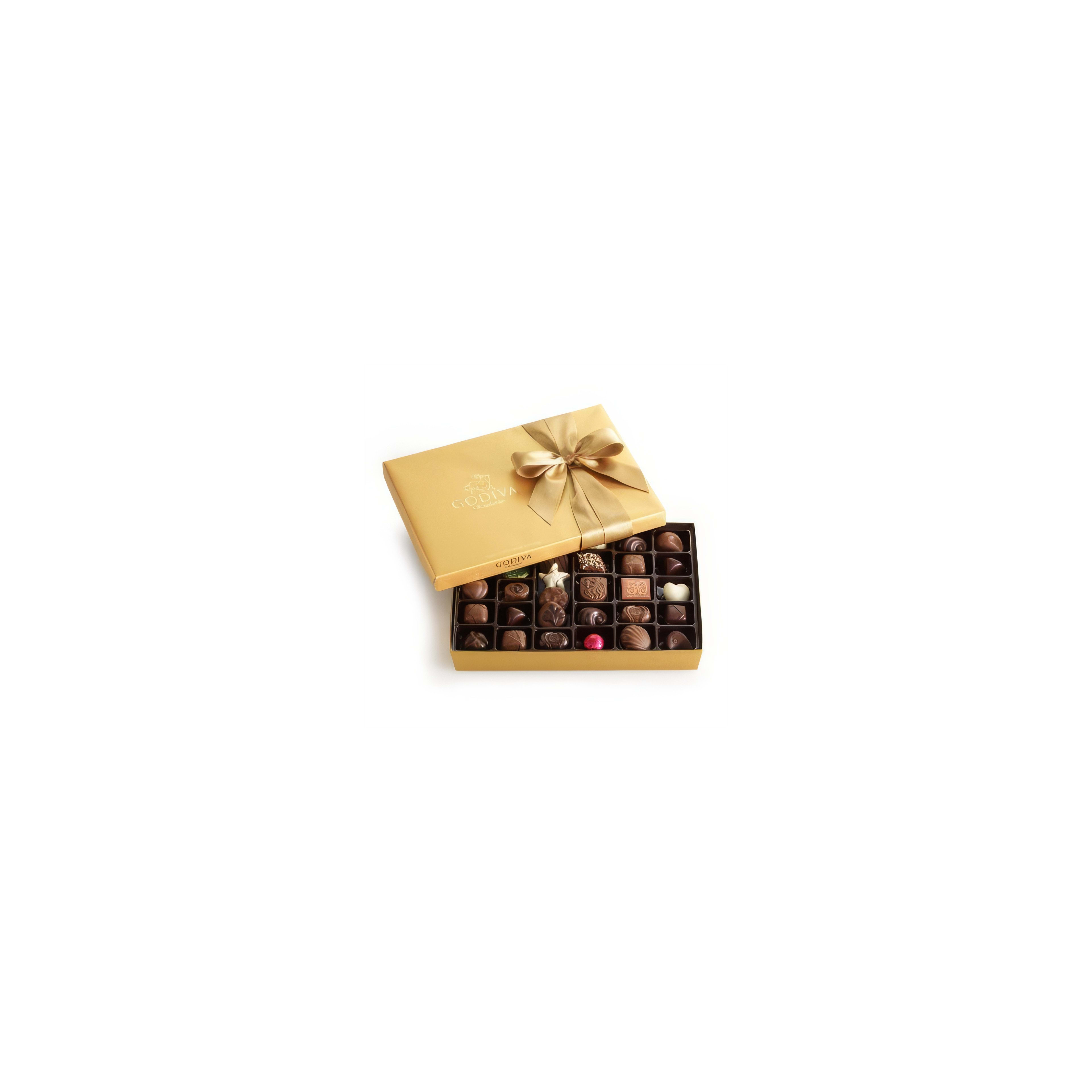 A golden box of assorted chocolates is open to reveal a tempting variety of treats inside.