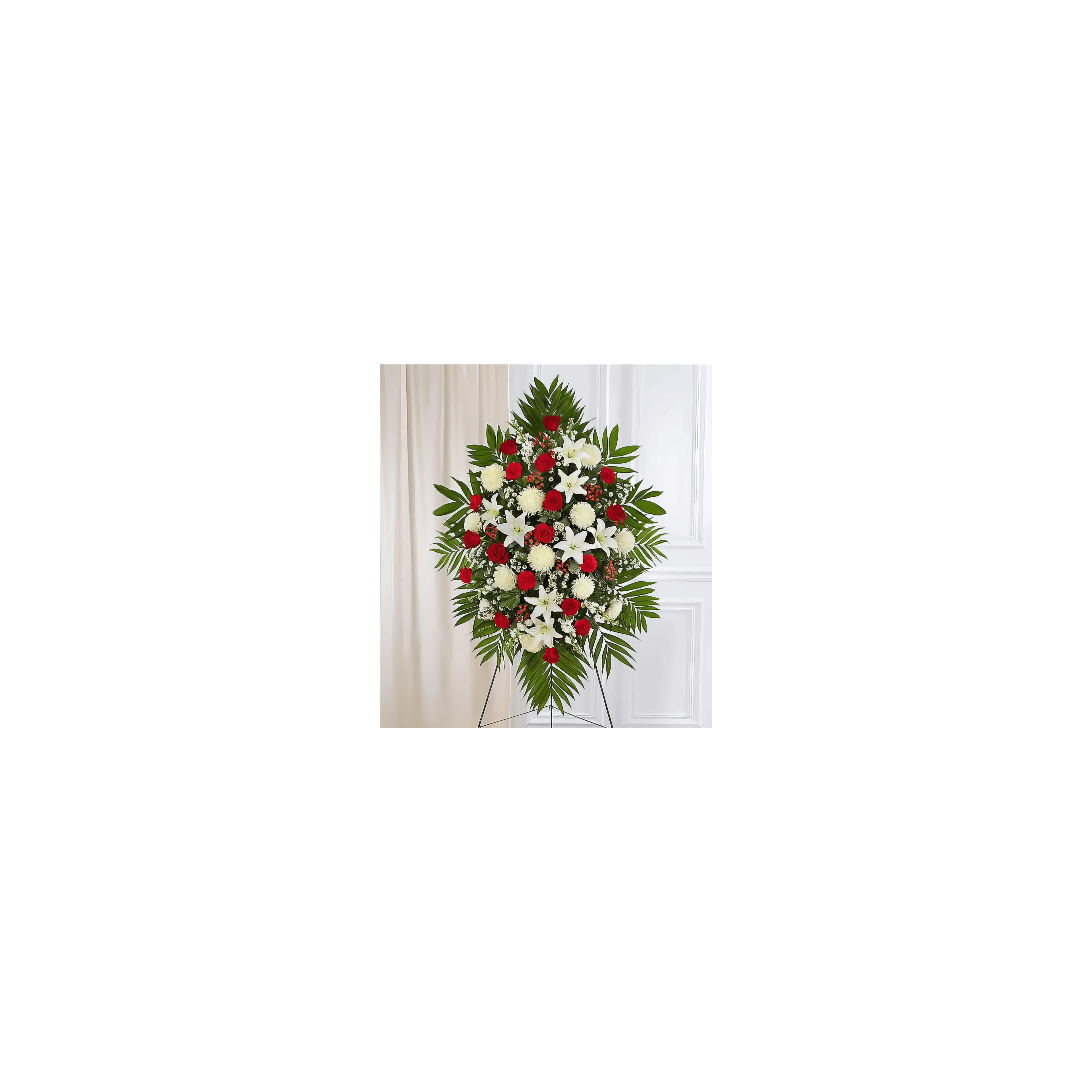 Colorful flowers including red roses and white lilies are arranged beautifully indoors.