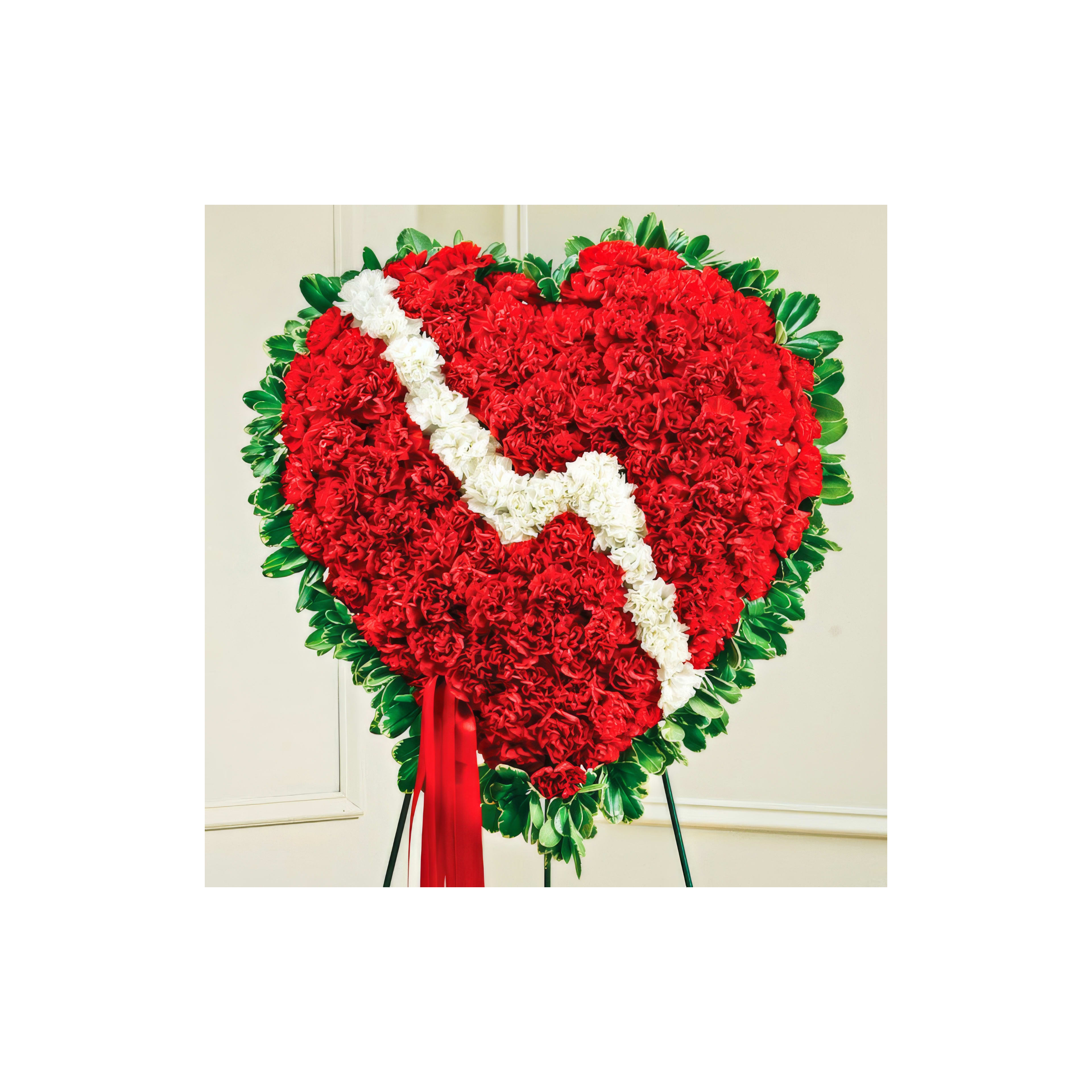 Heart-shaped floral arrangement with red and white flowers, perfect for a sentimental occasion.