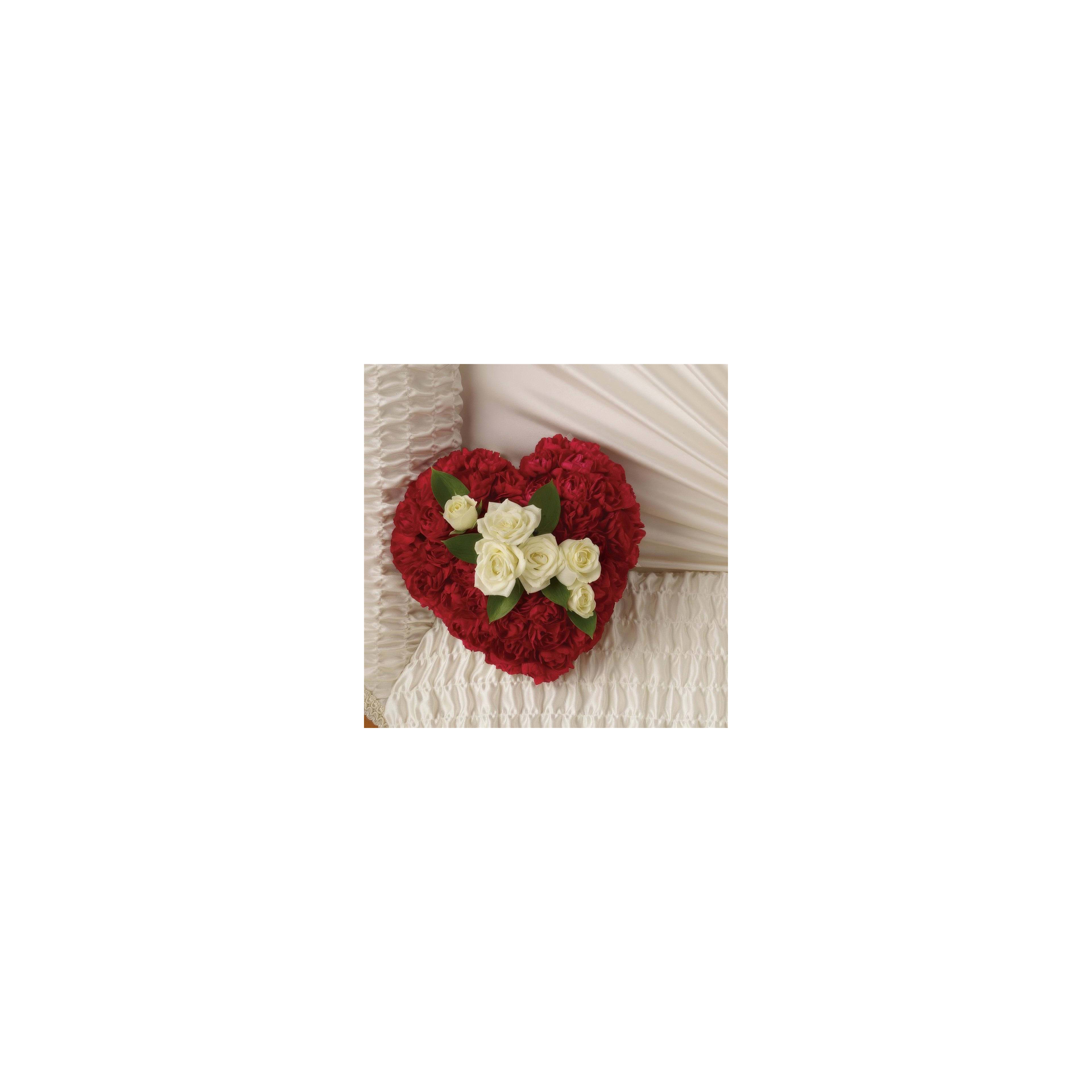 Beautiful heart-shaped flower arrangement featuring red and white roses on soft fabric.