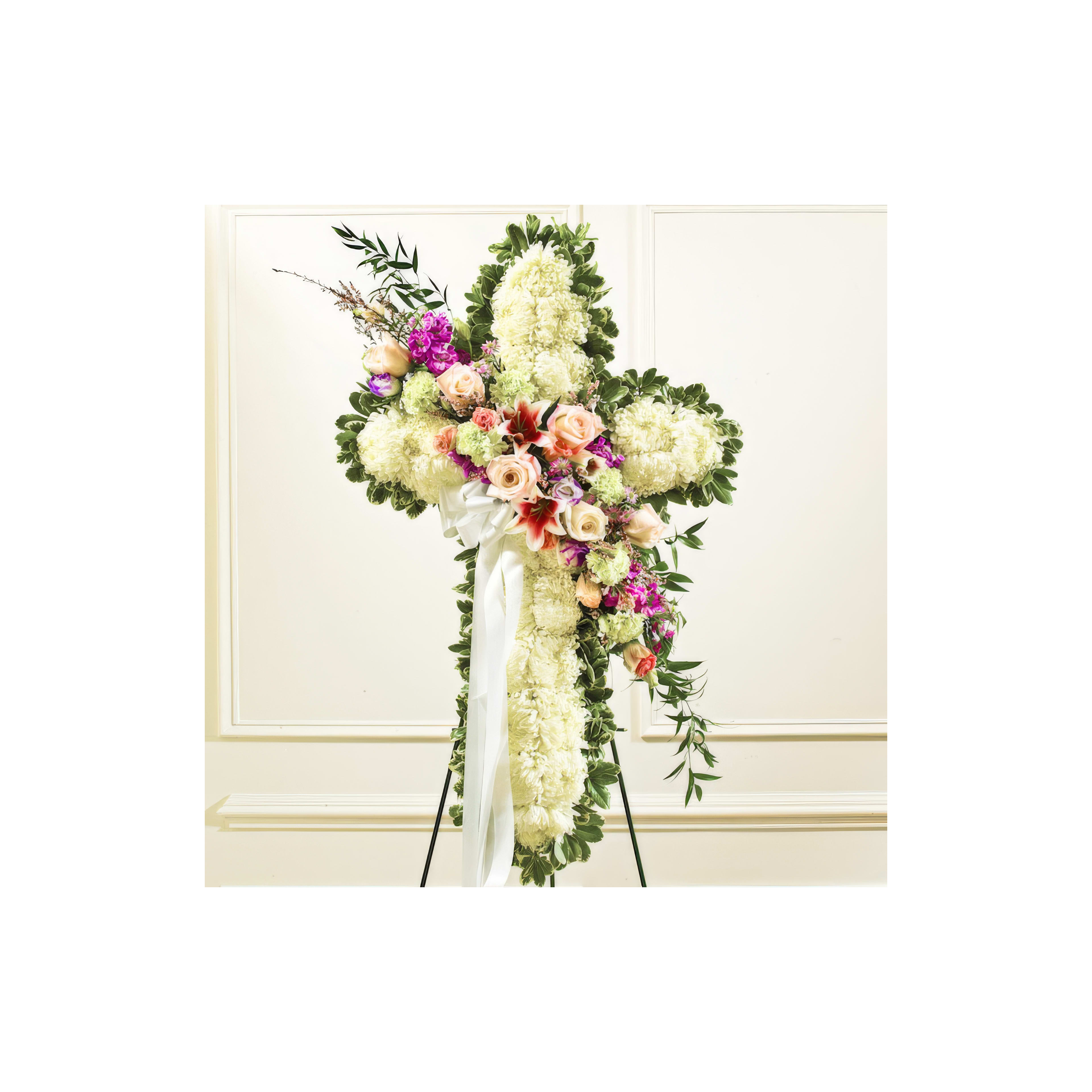 Elegant floral cross decorated with vibrant flowers, honoring a loved one during a memorial service.