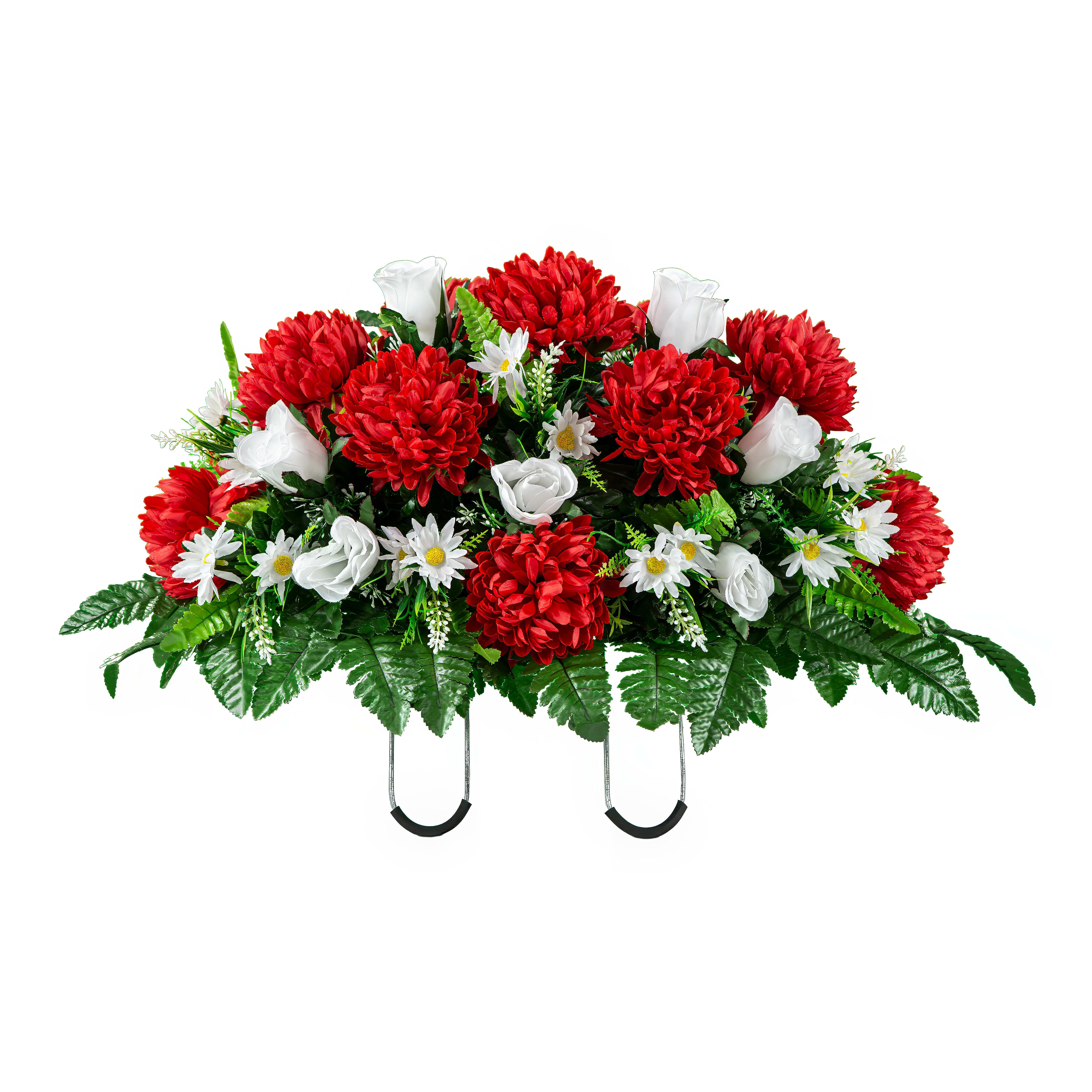 A bright bouquet of red and white flowers stands out against lush green foliage.