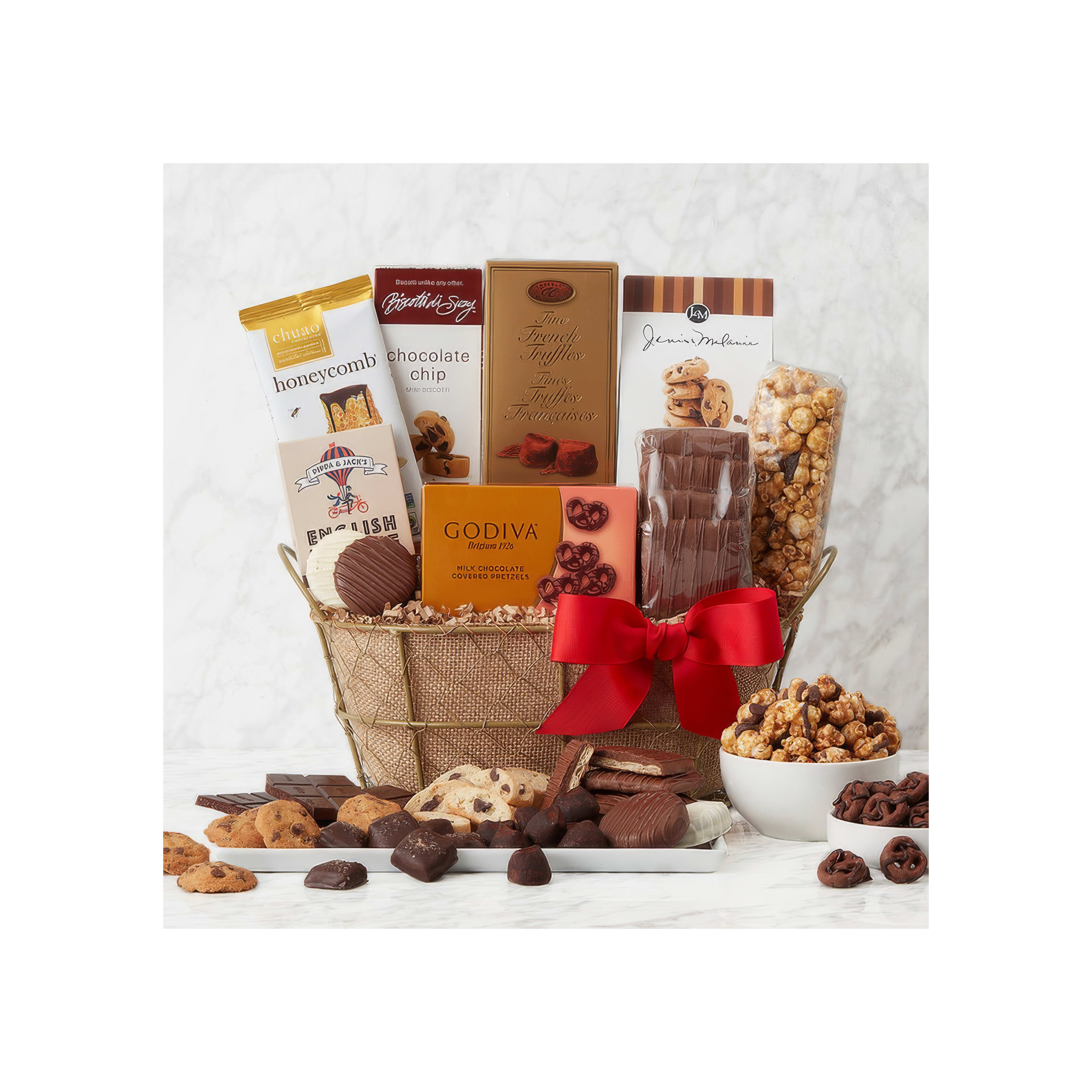 A collection of gourmet sweets displayed beautifully in a woven basket with a red ribbon.