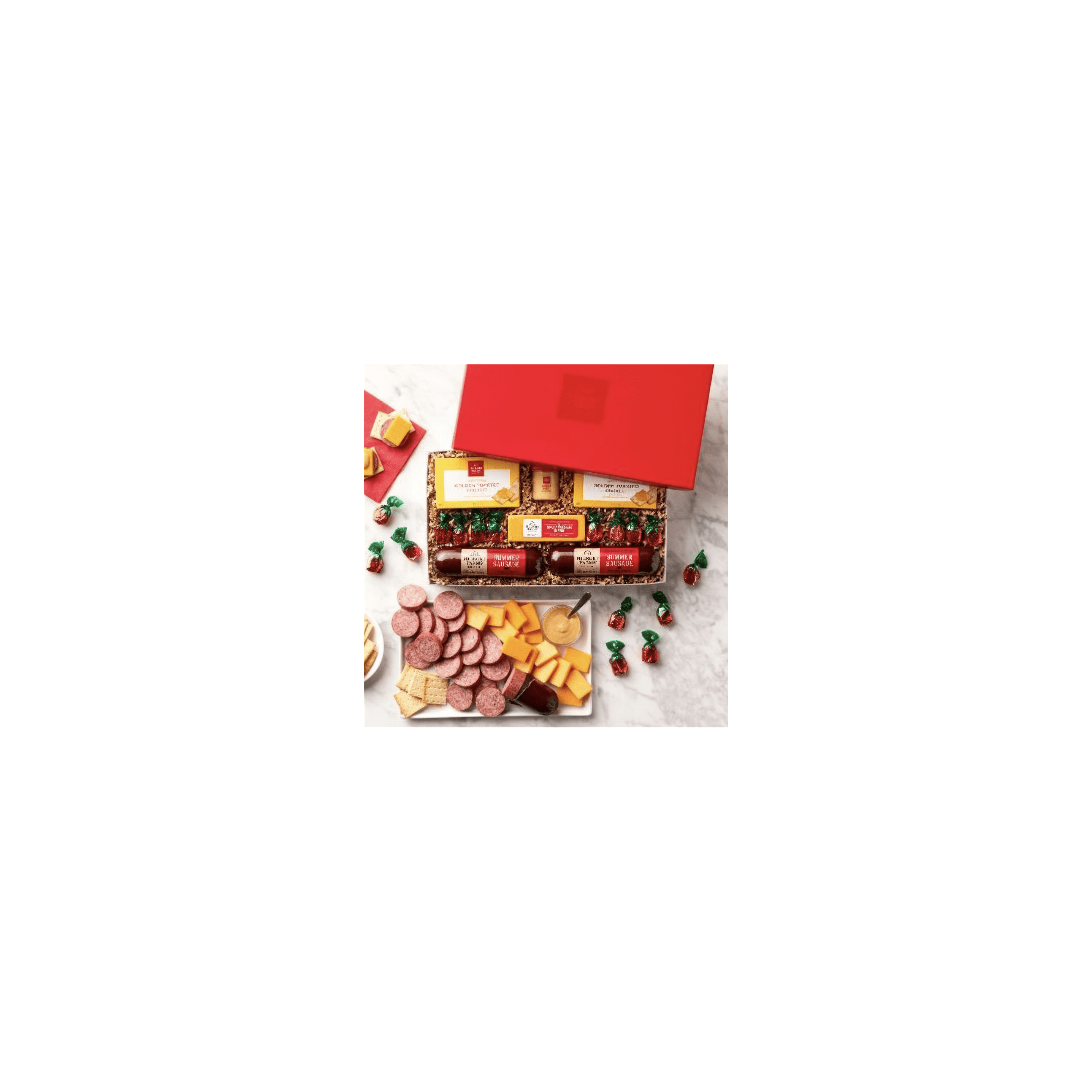 Gift box showcases a variety of cheeses, meats, snacks, and delectable treats for sharing.