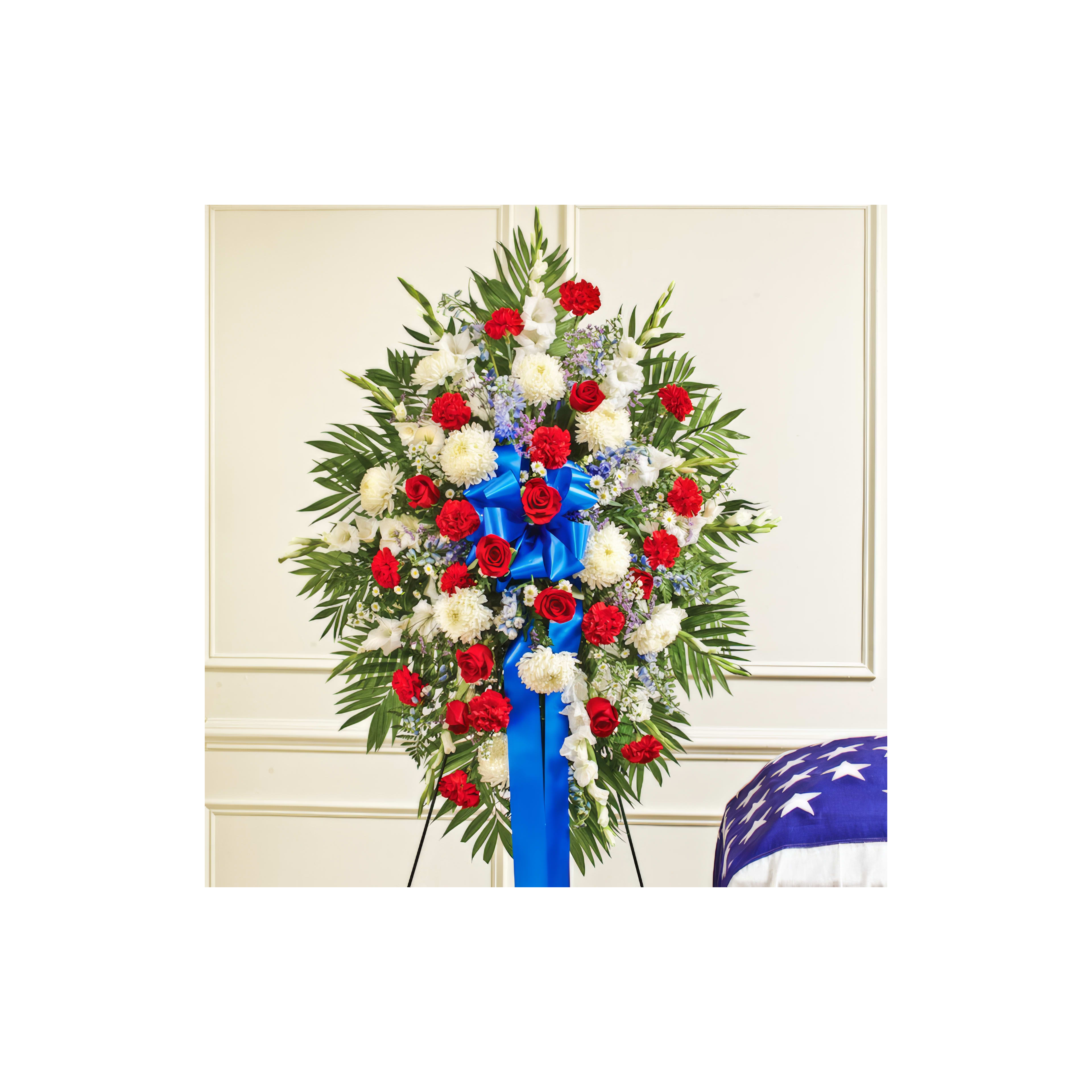 A colorful floral tribute featuring roses and daisies, arranged for a solemn occasion.