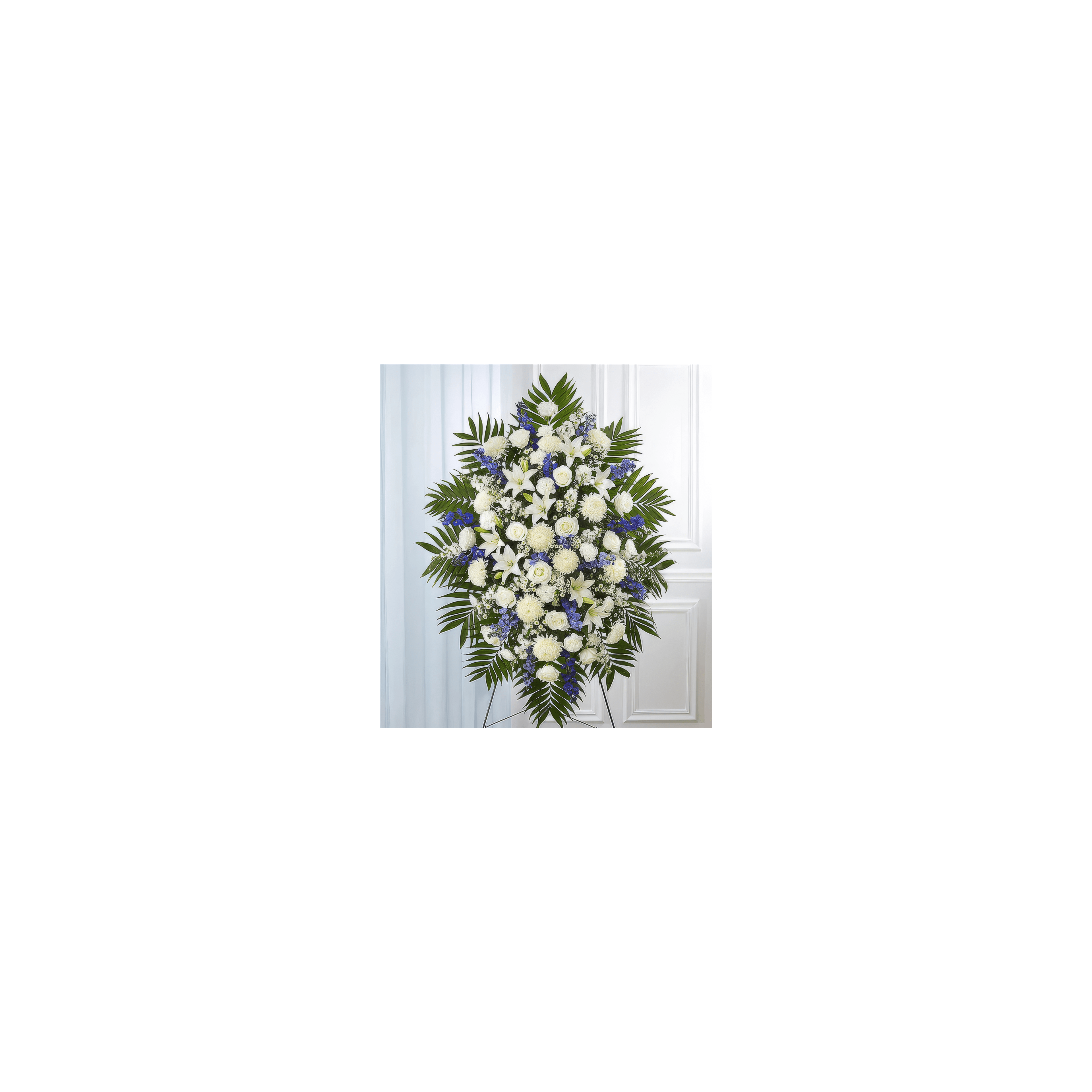 Elegant floral tribute with white roses, lilies, and blue accents on a neutral background.