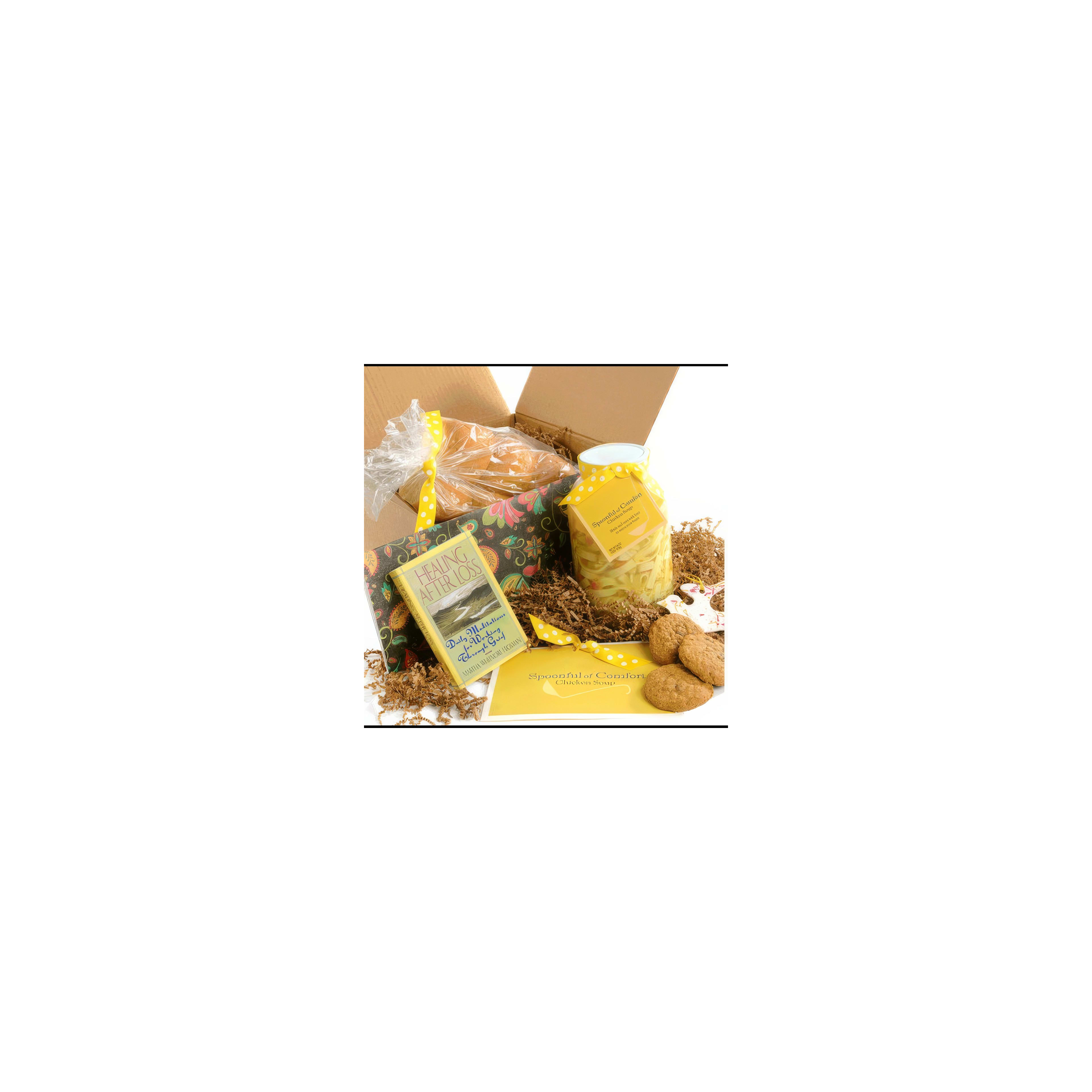 A gift box features fresh homemade soup, cookies, and a book on a light background.