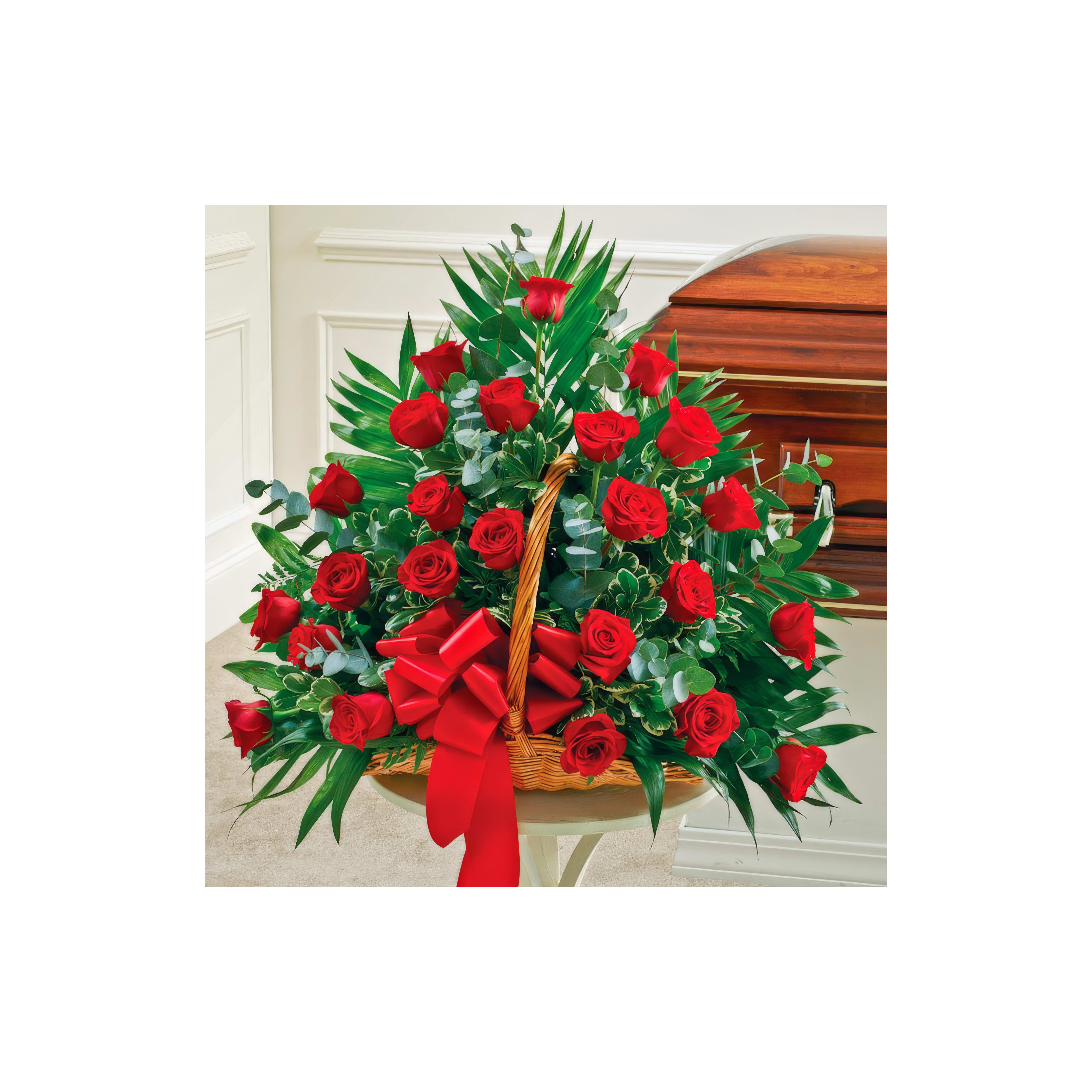 Beautiful red roses are arranged in a decorative basket, surrounded by greenery.