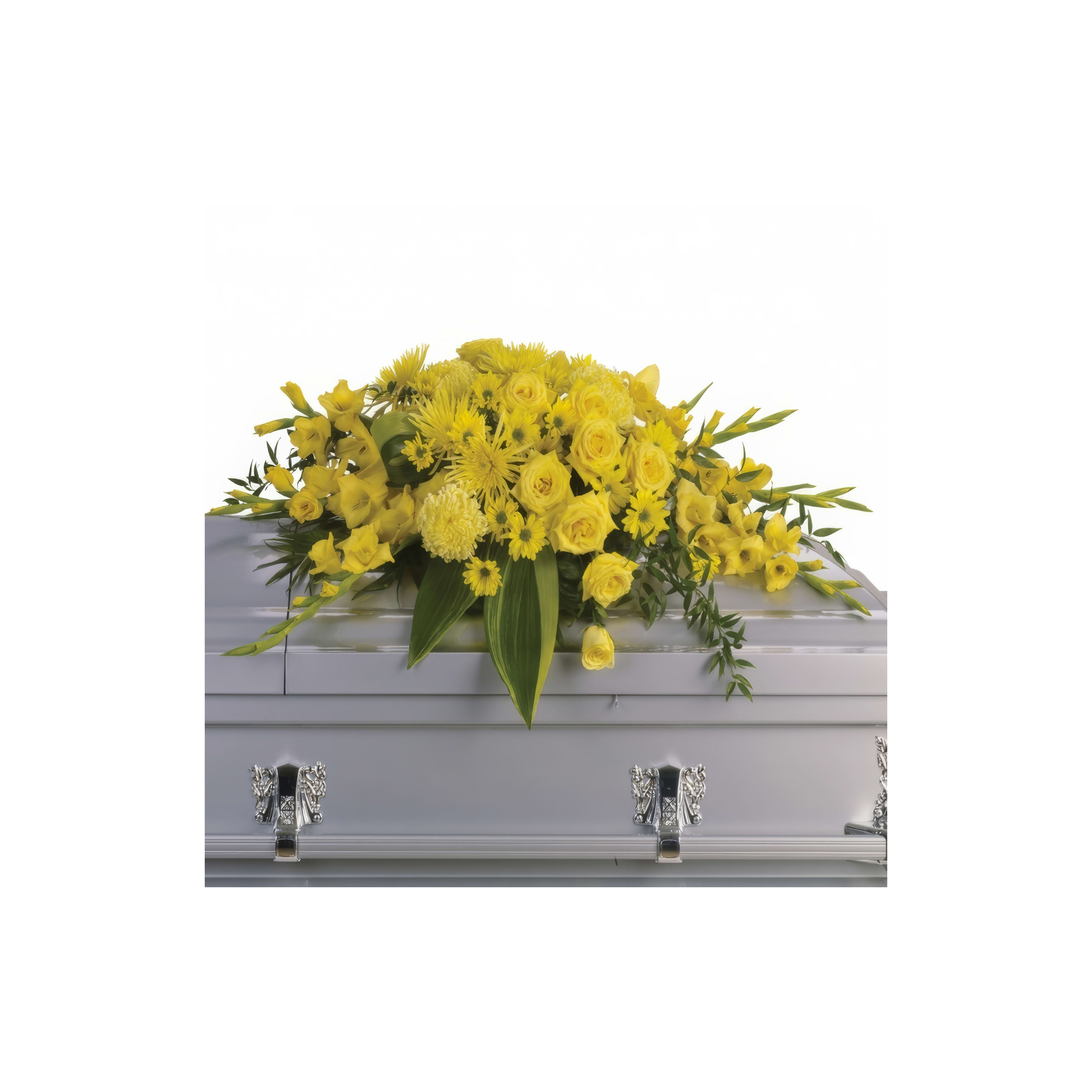 A vibrant display of yellow flowers rests on a silver casket during a memorial service.