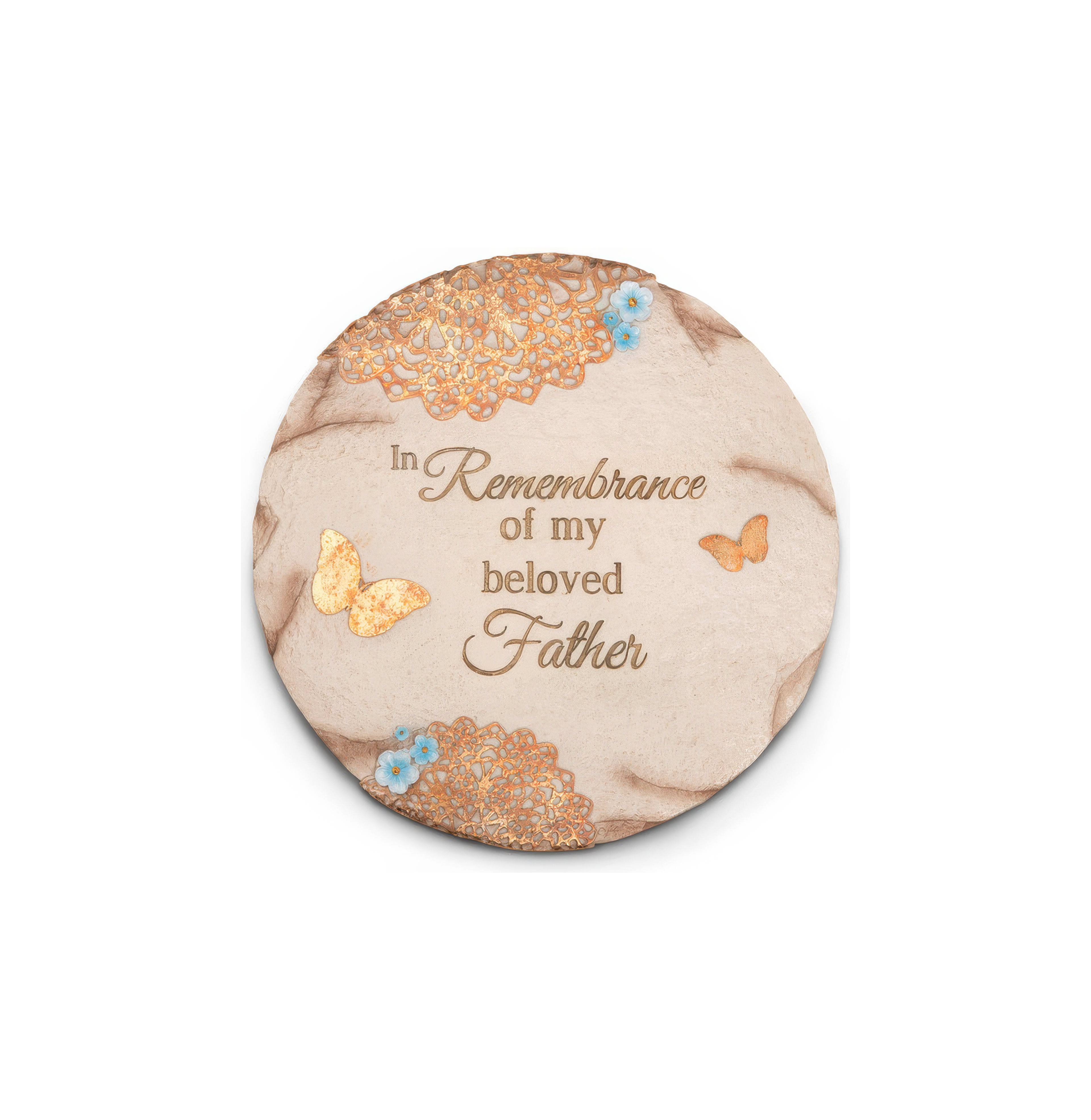 A memorial stone features heartfelt text, butterflies, and floral designs to honor a father.