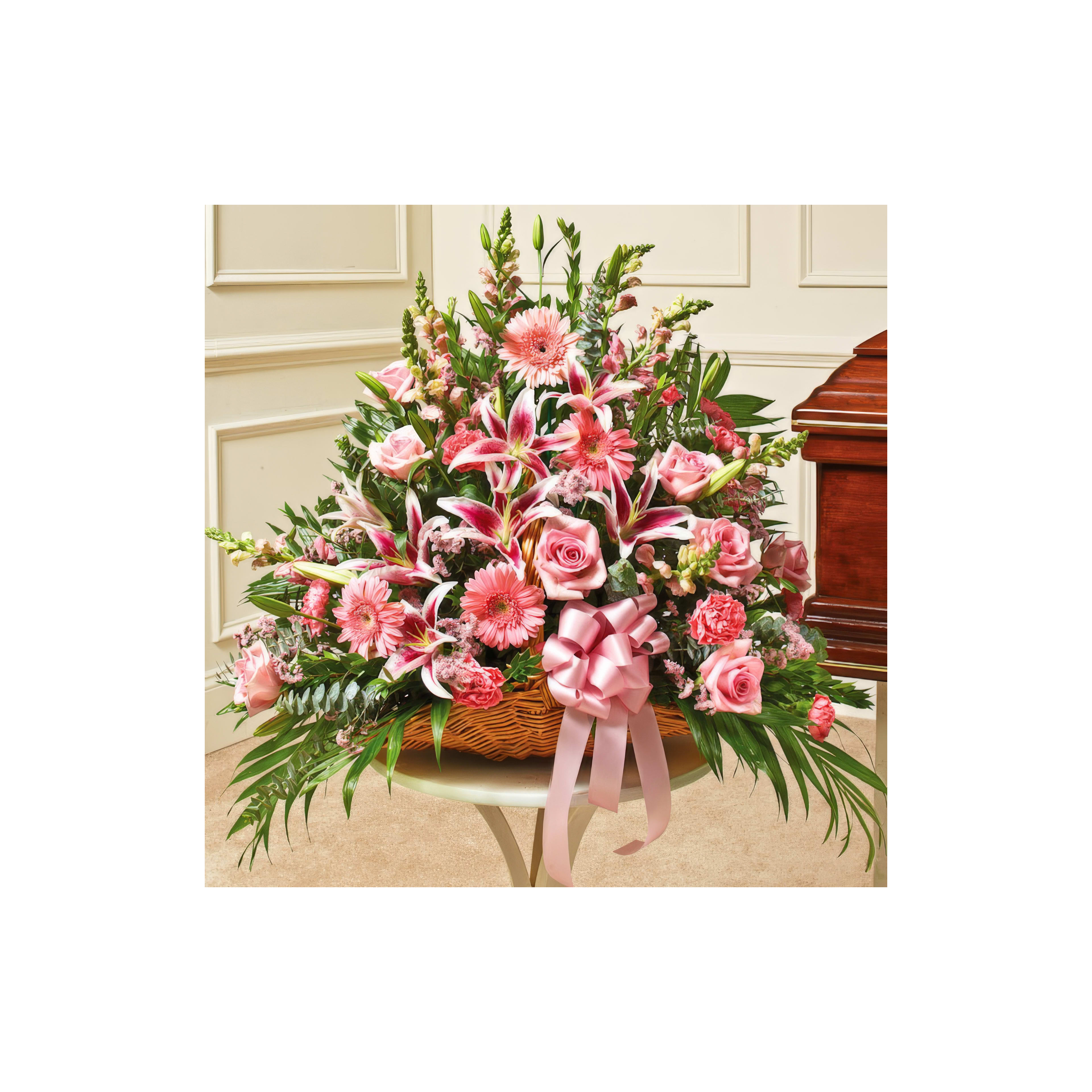 A stunning floral arrangement featuring pink roses and lilies in an elegant indoor environment.