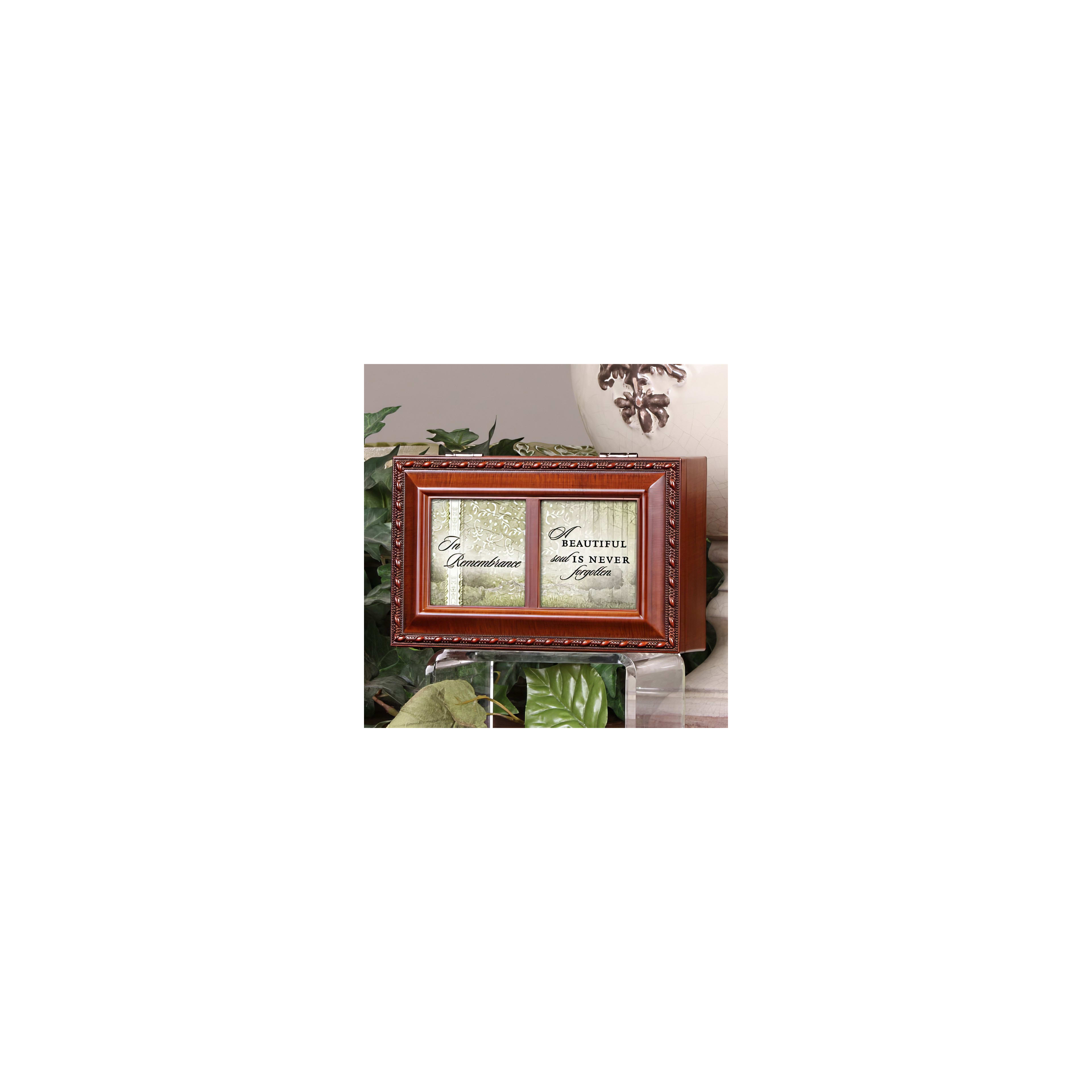 A wooden box with a heartfelt phrase about beauty and memories sits amid green plants.