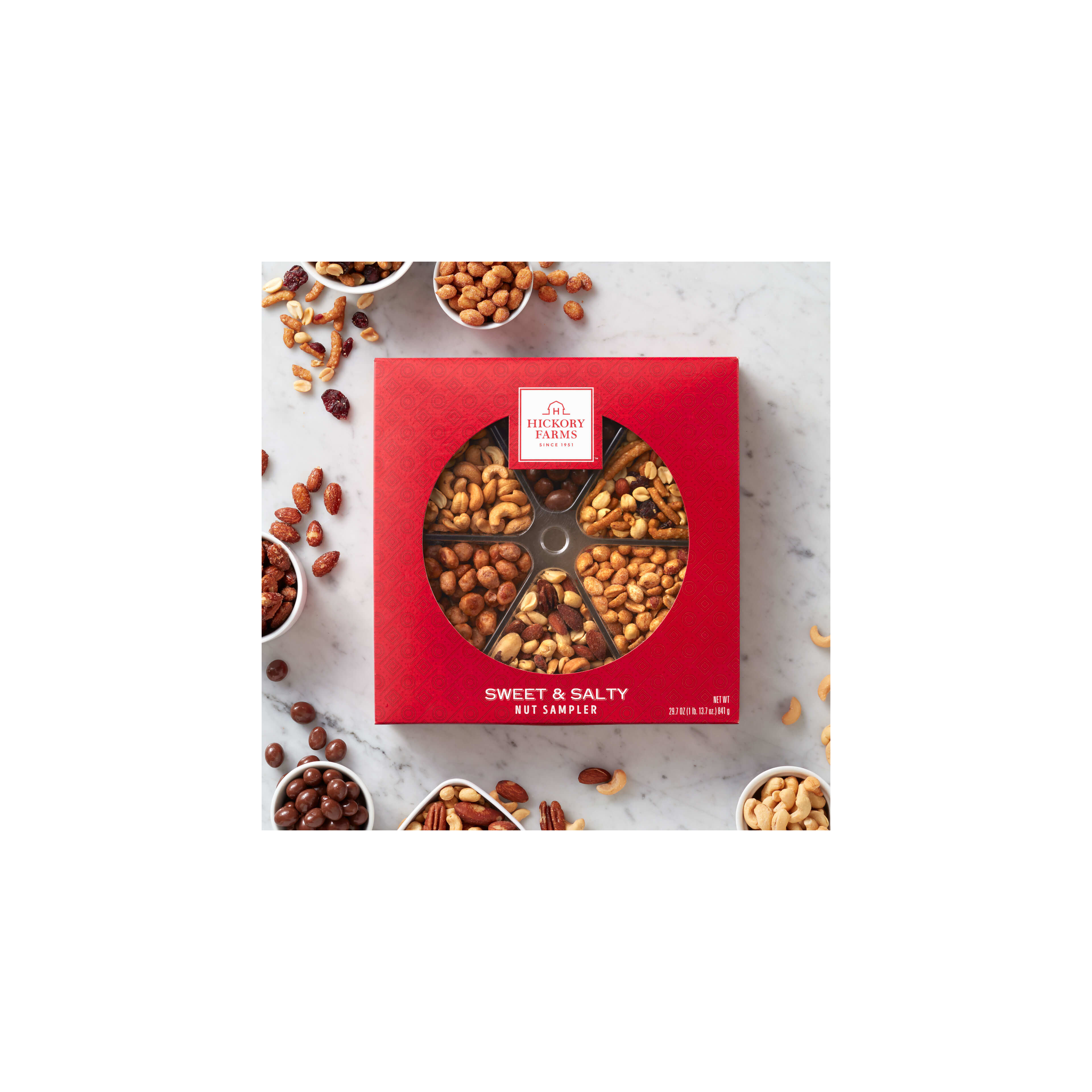 A colorful nut sampler box showcases various nut types arranged in small bowls.