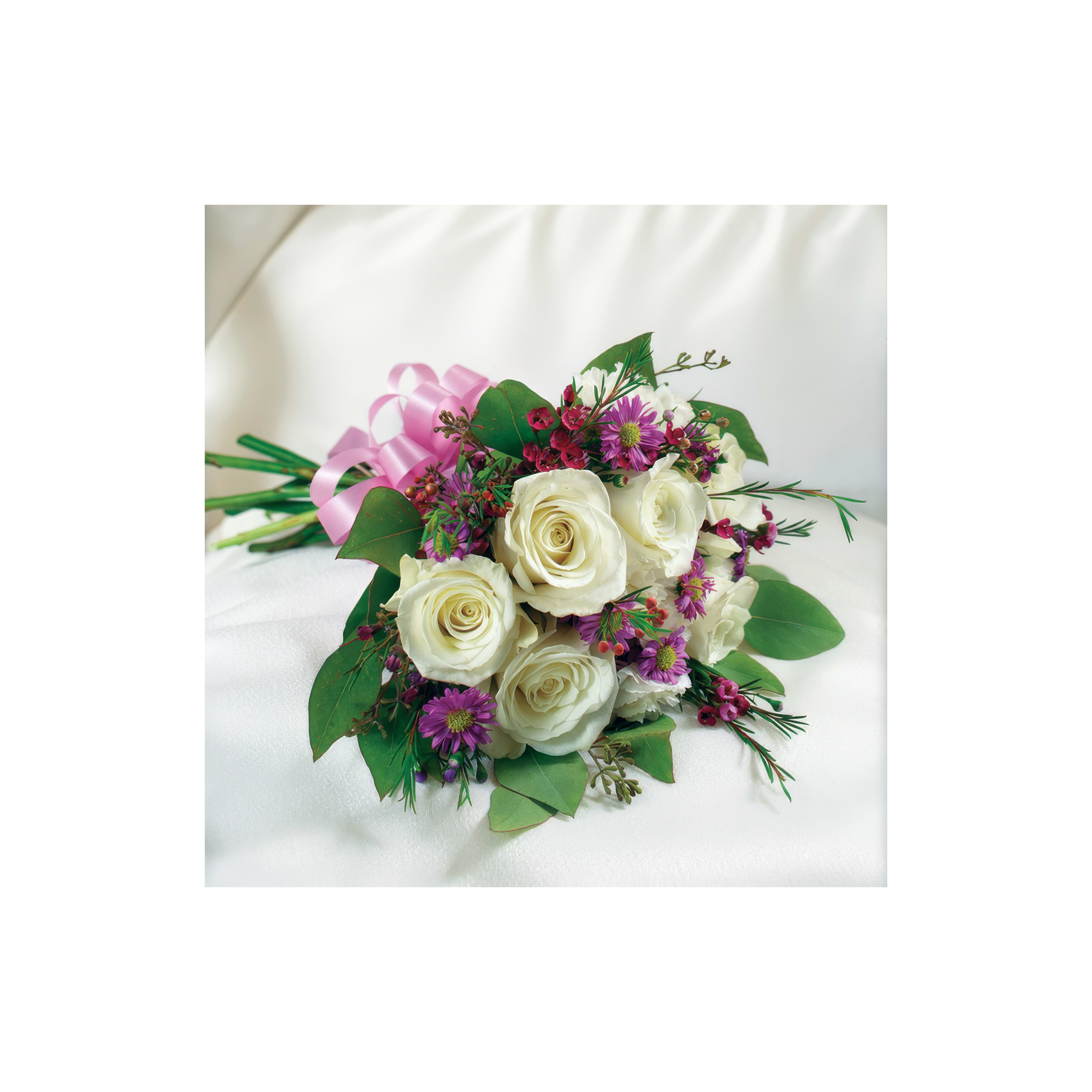 A stunning bouquet features white roses and various vibrant flowers, perfect for celebrations.