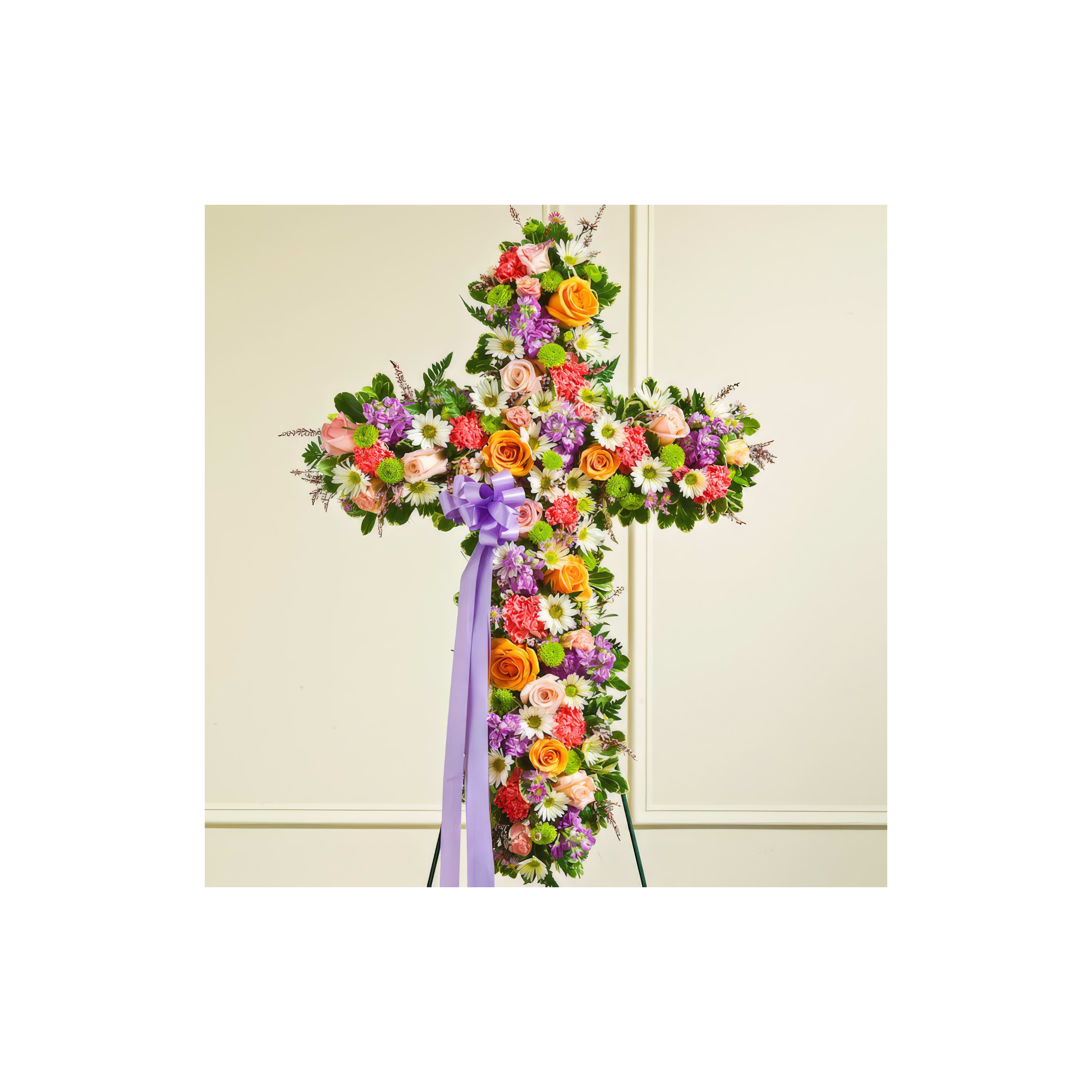 A stunning floral cross arrangement made of roses, daisies, and other blooms for a memorial service.