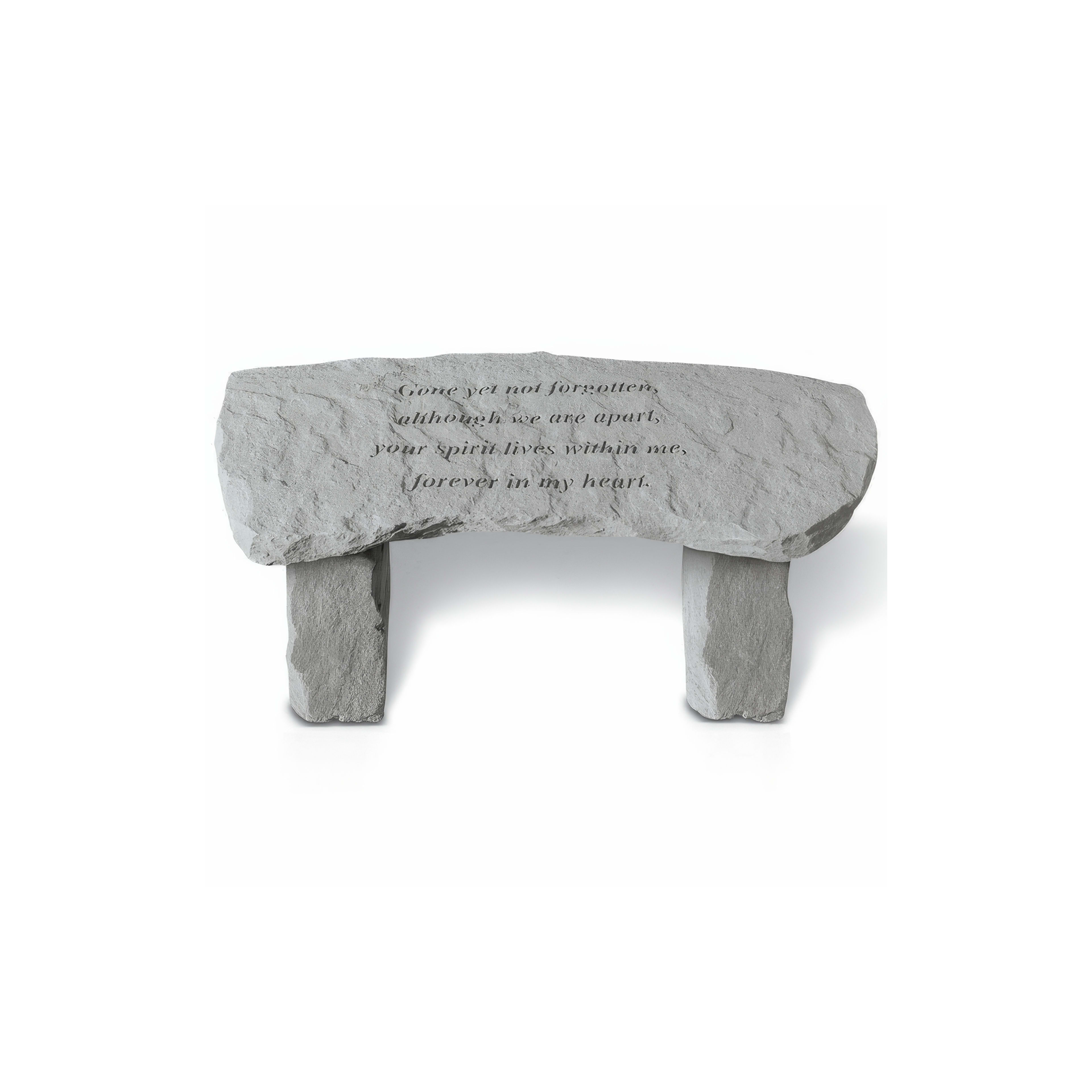 A serene stone bench features an inscription honoring loved ones in a tranquil garden area.