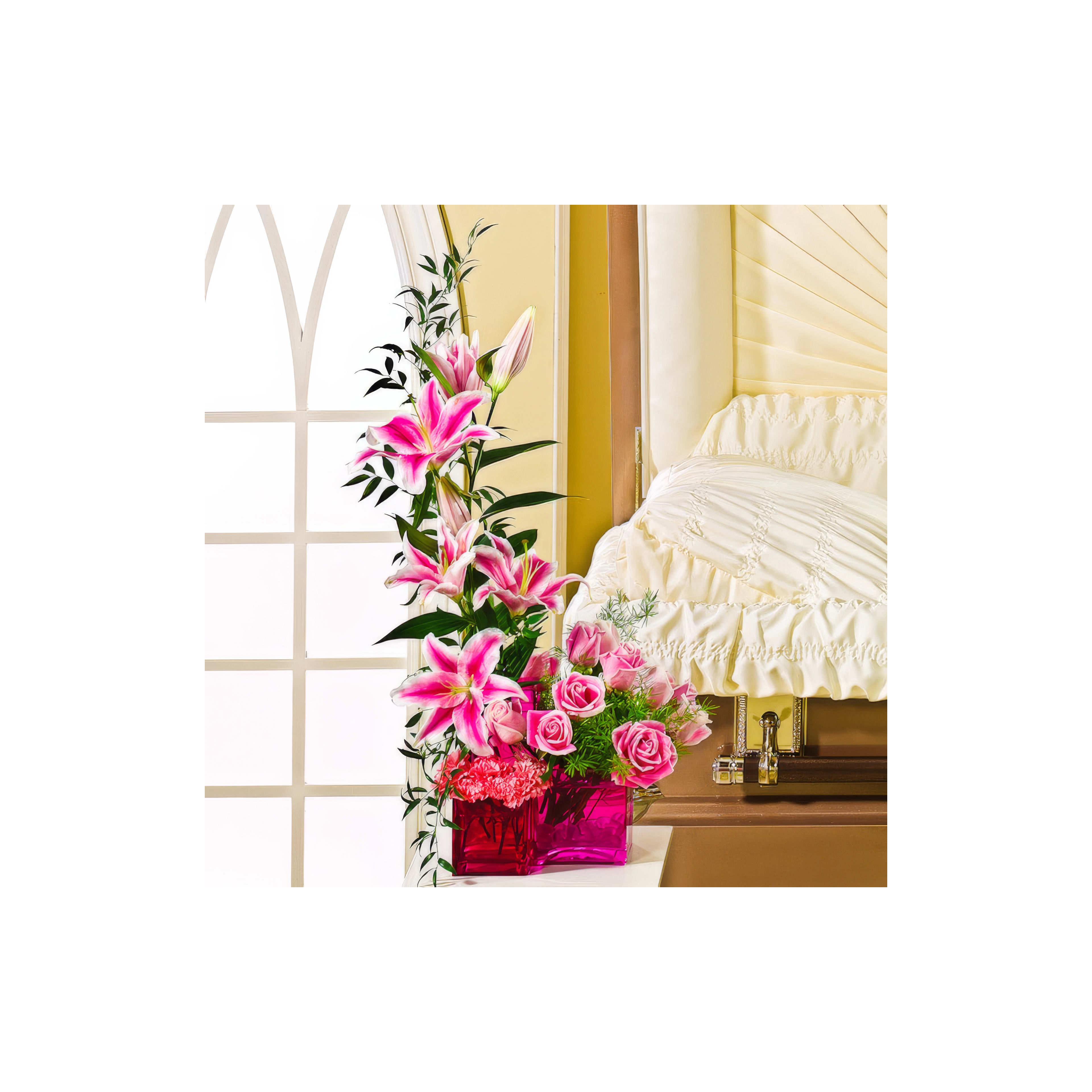 A beautiful arrangement of pink lilies and roses enhances the cozy atmosphere of the bedroom.