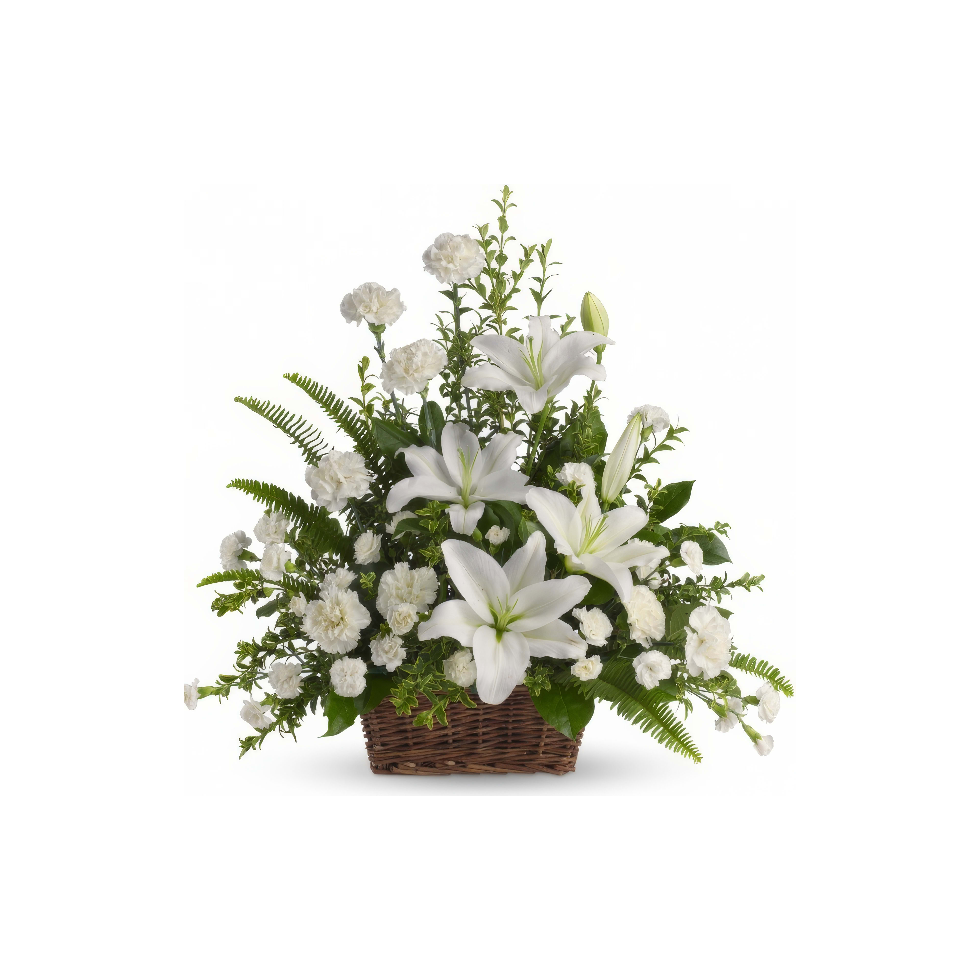 A beautiful arrangement features white lilies and carnations, perfect for celebrations or memorials.